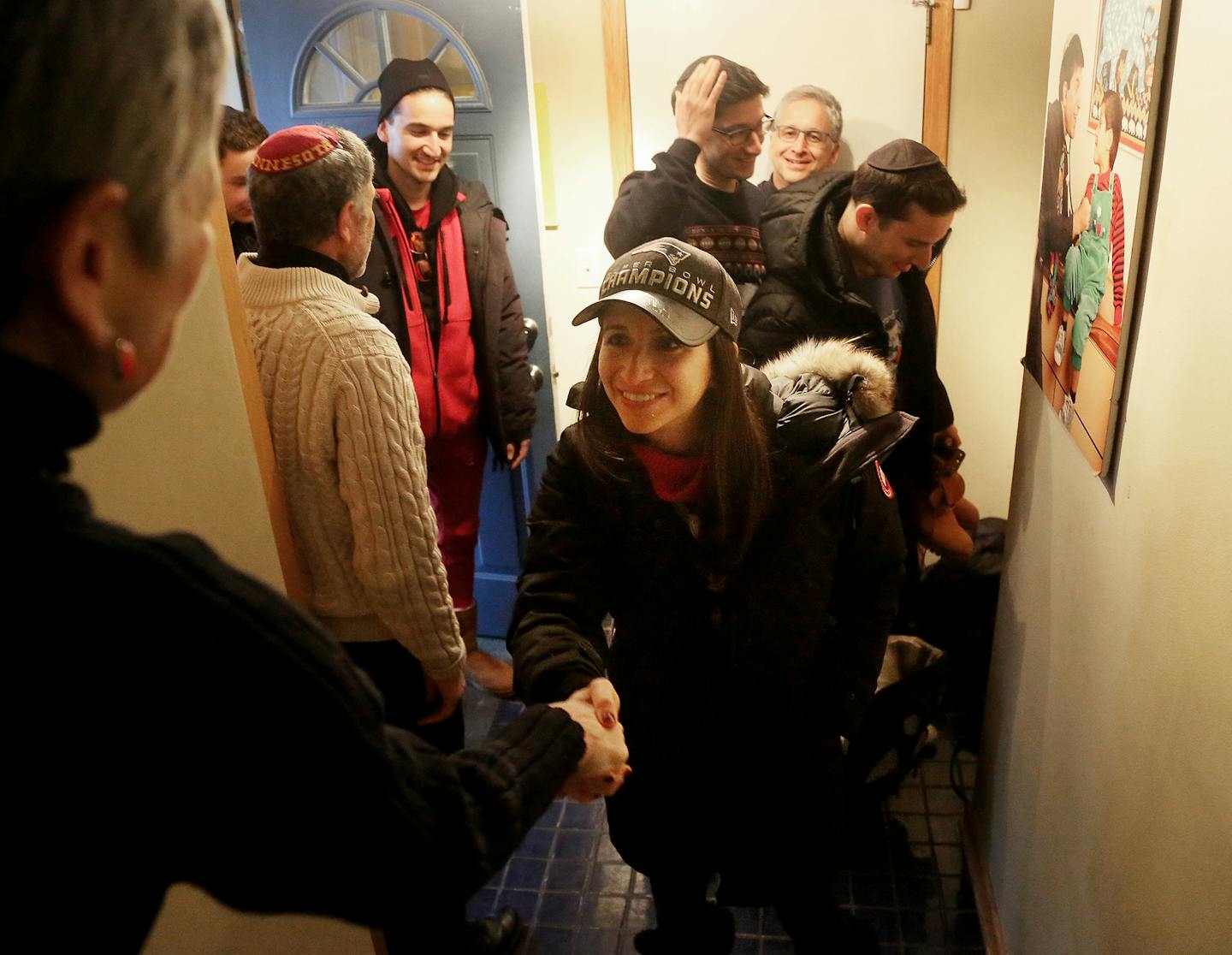 Hanna Bloomfield, left to right and her husband Bob Karasov welcomed New England Patriots super fan family from Boston Naty Katz, rear right, and his five children and a friend as they arrived to stay for the Super Bowl at Katz and Bloomfield's house Friday, Feb. 2, 2018, in St. Louis Park, MN. Katz and Bloomfield had made the offer through their St. Louis Park synagogue for fellow traveling orthodox Jews coming to Minneapolis for the Super Bowl.] DAVID JOLES &#xef; david.joles@startribune.com A