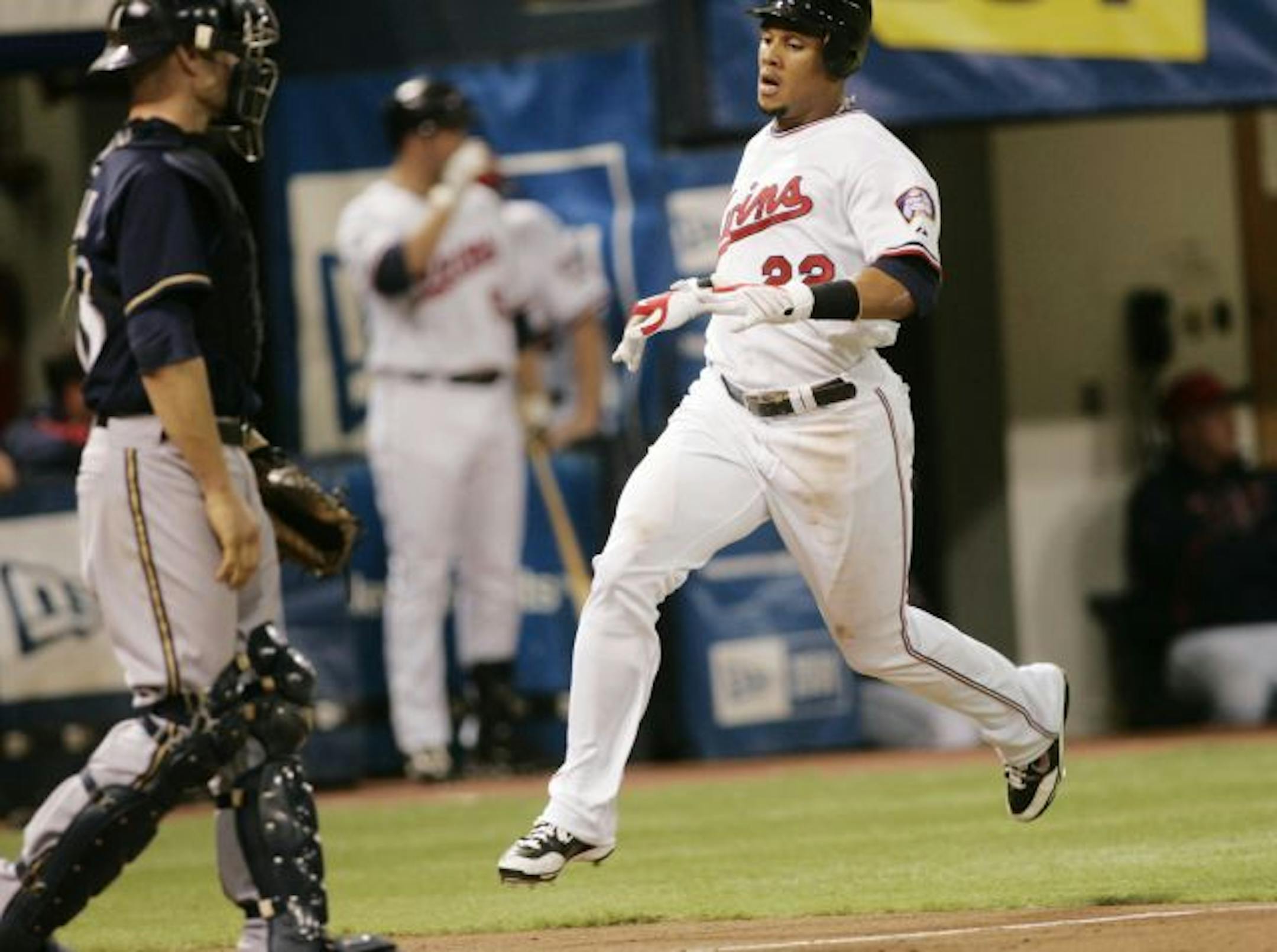 Minnesota Twins center fielder Carlos Gomez scores during the 3-run 3rd inning on a 2- RBI single by Joe Mauer during action with the Milwaukee Brewers at the Metrodome.