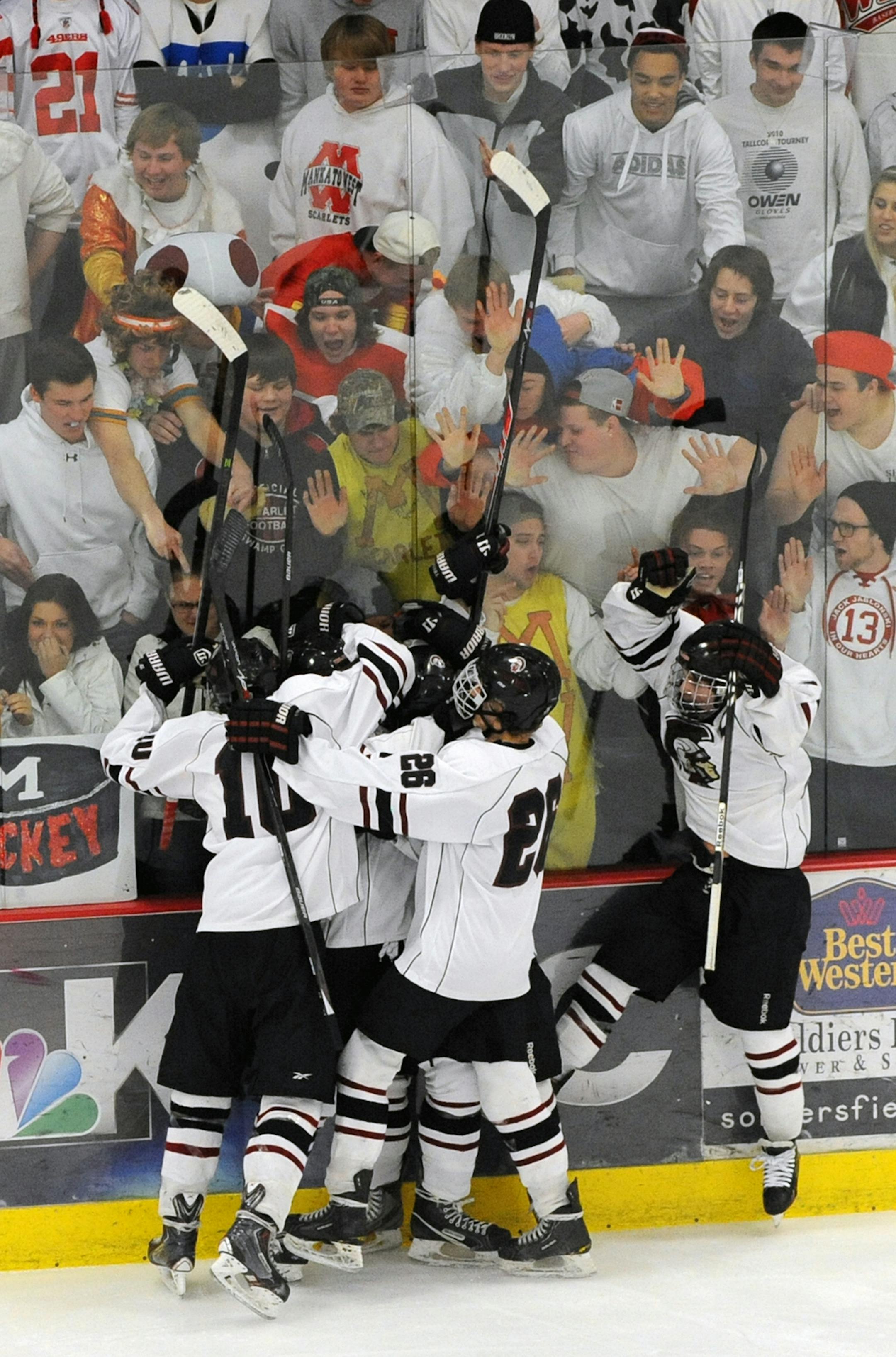New Prague celebrates a 3-2 Section 1A championship victory vs. Mankato West. Photo: Loren Nelson