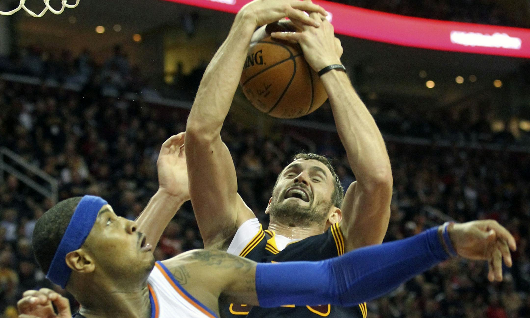The Cleveland Cavaliers' Kevin Love grabs a fourth-quarter rebound over the New York Knicks' Carmello Anthony (7) on Thursday, Oct. 30, 2014, at Quicken Loans Arena in Cleveland. The Knicks won, 95-90. (Phil Masturzo/Akron Beacon Journal/MCT)