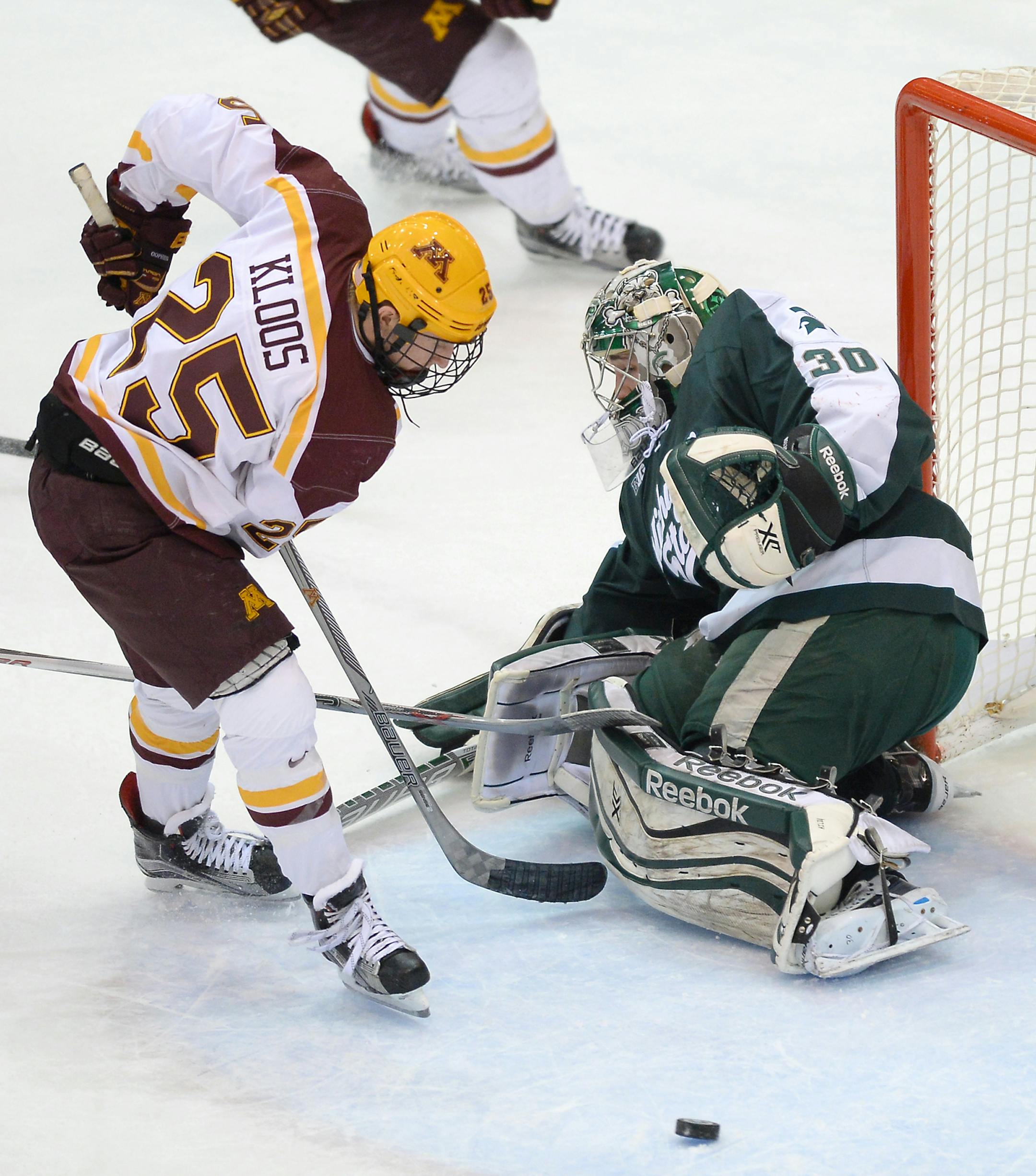 Minnesota Golden Gophers center Justin Kloos (25) nearly scored on Michigan State Spartans goalie Jake Hildebrand (30) before being cross checked from behind by Michigan State Spartans defenseman Carson Gatt (18) in the final minute of the first period Friday. ] (AARON LAVINSKY/STAR TRIBUNE) aaron.lavinsky@startribune.com The University of Minnesota Golden Gophers mens' hockey team played the Michigan State University Spartans on Friday, Jan. 15, 2016 at Mariucci Arena in Minneapolis, Minn.