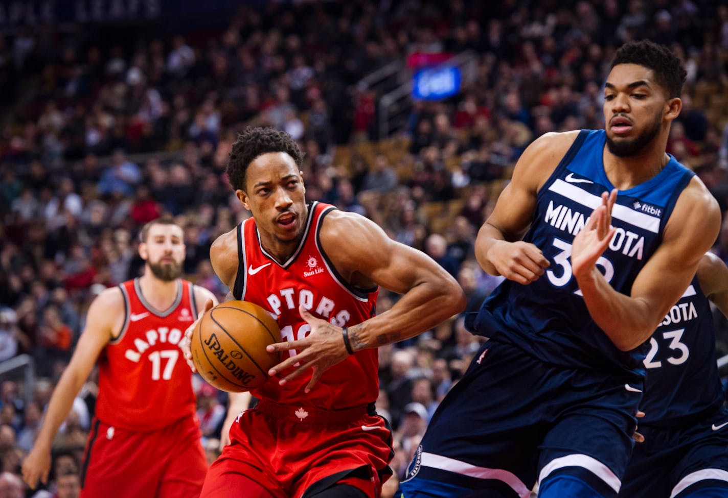 Toronto Raptors guard DeMar DeRozan (10) moves in on Minnesota Timberwolves Karl-Anthony Towns, right, during the first half of an NBA basketball game, Tuesday, Jan. 30, 2018 in Toronto.