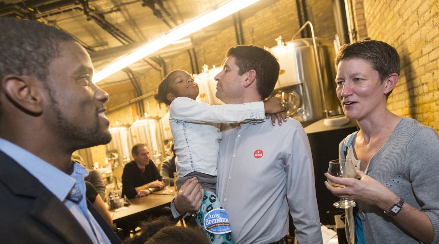 Former Saint Paul city councilman from ward one, Melvin Carter, left, spoke to Betsy Murray, spouse of St. Paul Ward 4 City Council incumbent Russ Stark, center, as Stark held Carter's 7-year-old daughter, Naomi, during the DFL election party Tuesday night at Urban Growler. ] (AARON LAVINSKY/STAR TRIBUNE) aaron.lavinsky@startribune.com All seven of St. Paul's City Council seats are up for election, including two open wards where incumbents didn't run again. As many as three who have challenged M