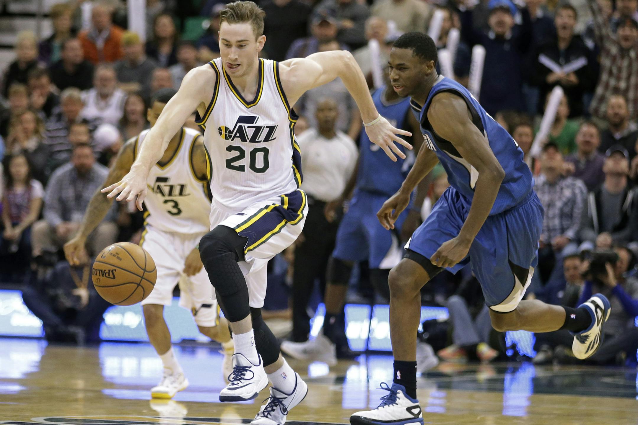 Utah Jazz forward Gordon Hayward (20) drives down the court after stealing the ball from Minnesota Timberwolves forward Andrew Wiggins, rear, in the fourth quarter during an NBA basketball game Tuesday, Dec. 30, 2014, in Salt Lake City. The Jazz won 100-94. (AP Photo/Rick Bowmer)