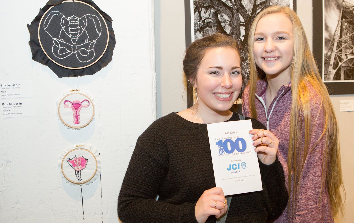 Brooke Berlin and Shelby Domagala stand next to Berlin's award-winning artwork.