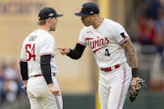 Minnesota Twins pitcher Sonny Gray (54) and Carlos Correa celebrate after their pickoff play in the fifth inning.