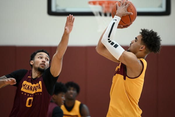 Freshman guard Tre' Williams (shooting against Payton Willis in practice) has shown potential as a long-range shooter for the Gophers, but he needs mi