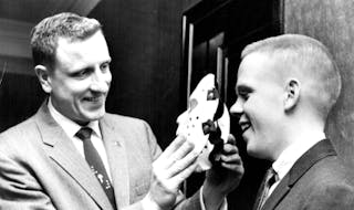 February 23, 1961 Roosevelt Coach Bob Johnson (Left) 'Masks' His Goale Eric Knox will wear plastic faceguard in state tourney February 22, 1961 Februa