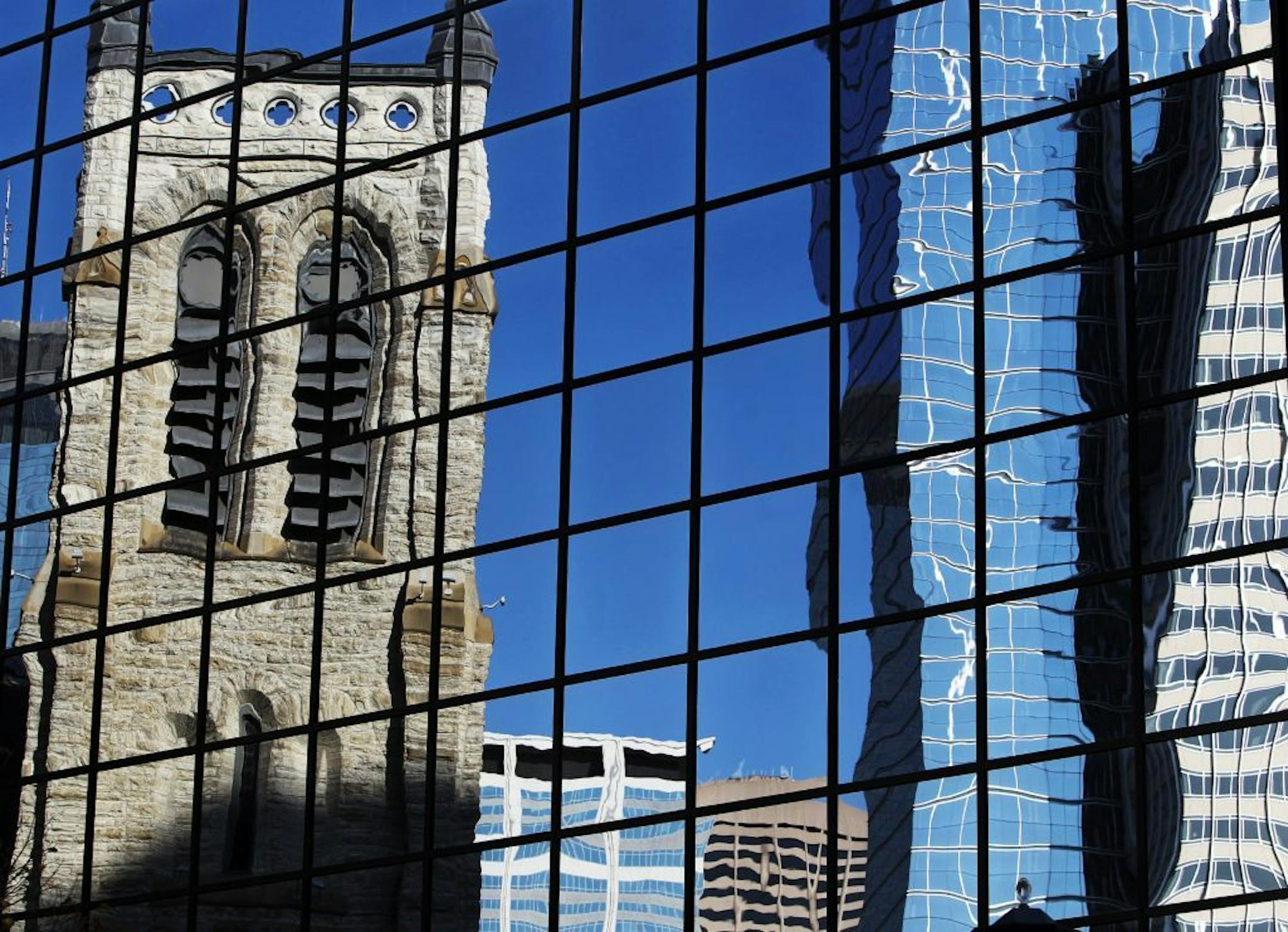 1221 Nicollet was purchased by Westminster Presbyterian Church, seen reflected in the windows of the office buildingThursday, Sept. 27, 2012. The office building was sold today for $8.7 million, part of a three-year project that seeks to bring more affordable housing units to downtown Minneapolis.