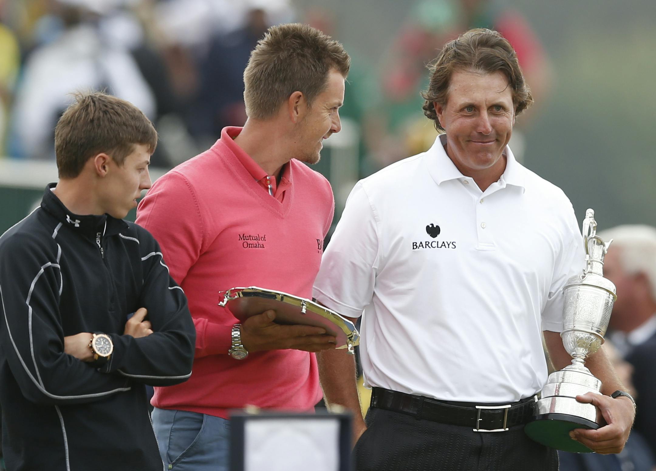 Phil Mickelson of the United States holds the Claret Jug trophy after winning the British Open Golf Championship with runner up Henrik Stenson of Sweden, center, and leading amateur Matthew Fitzpatrick of England, left, at Muirfield, Scotland, Sunday July 21, 2013. (AP Photo/Matt Dunham)