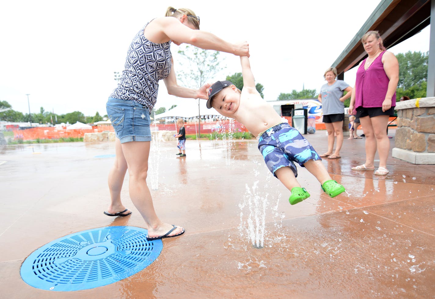 Rosemount resident Annie Peterson swung her 20-month-old son, Charlie, through a fountain.
Photo by Liz Rolfsmeier, Special to the Star Tribune