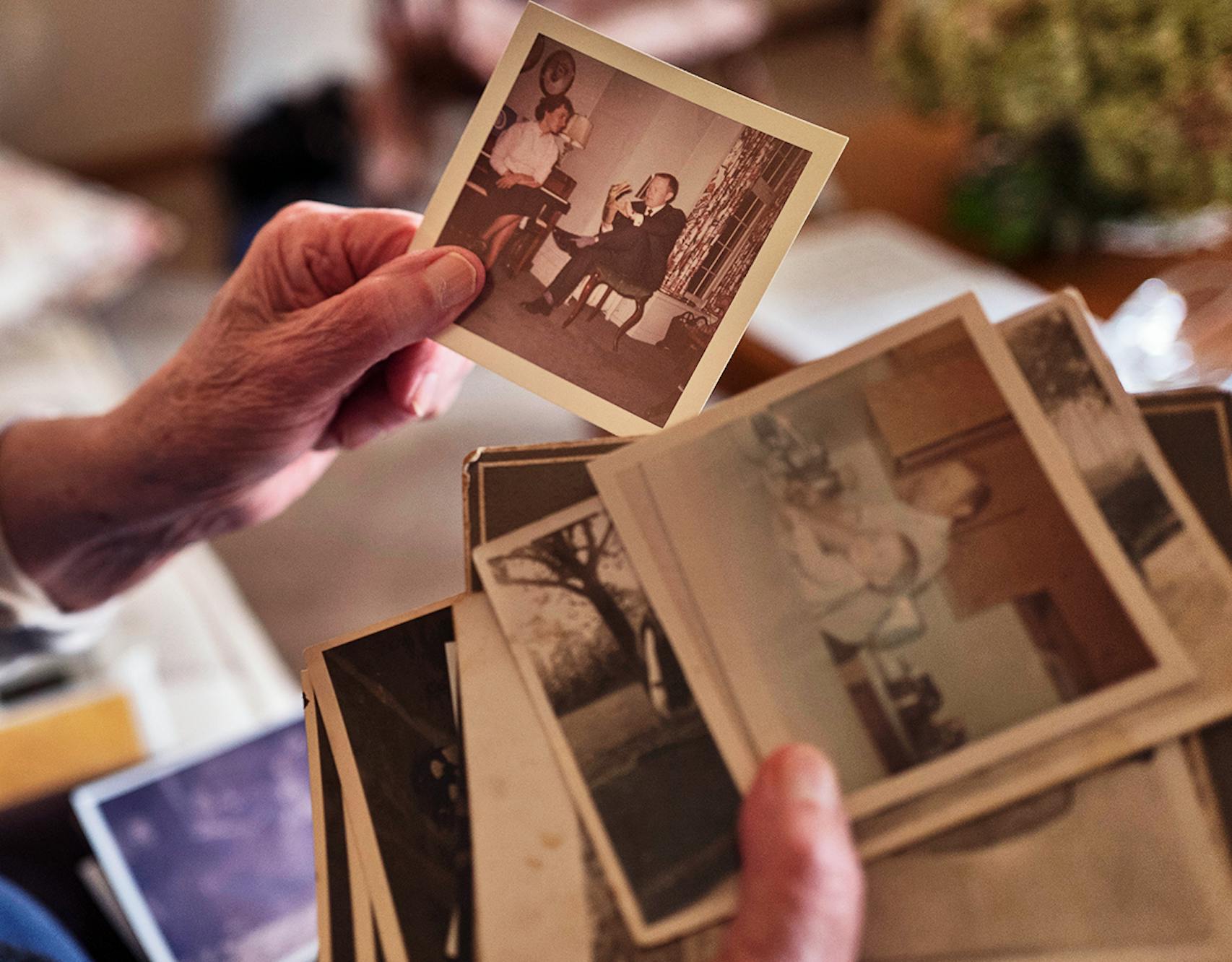 Helen Johnson, 88, holds photos of her husband and family.