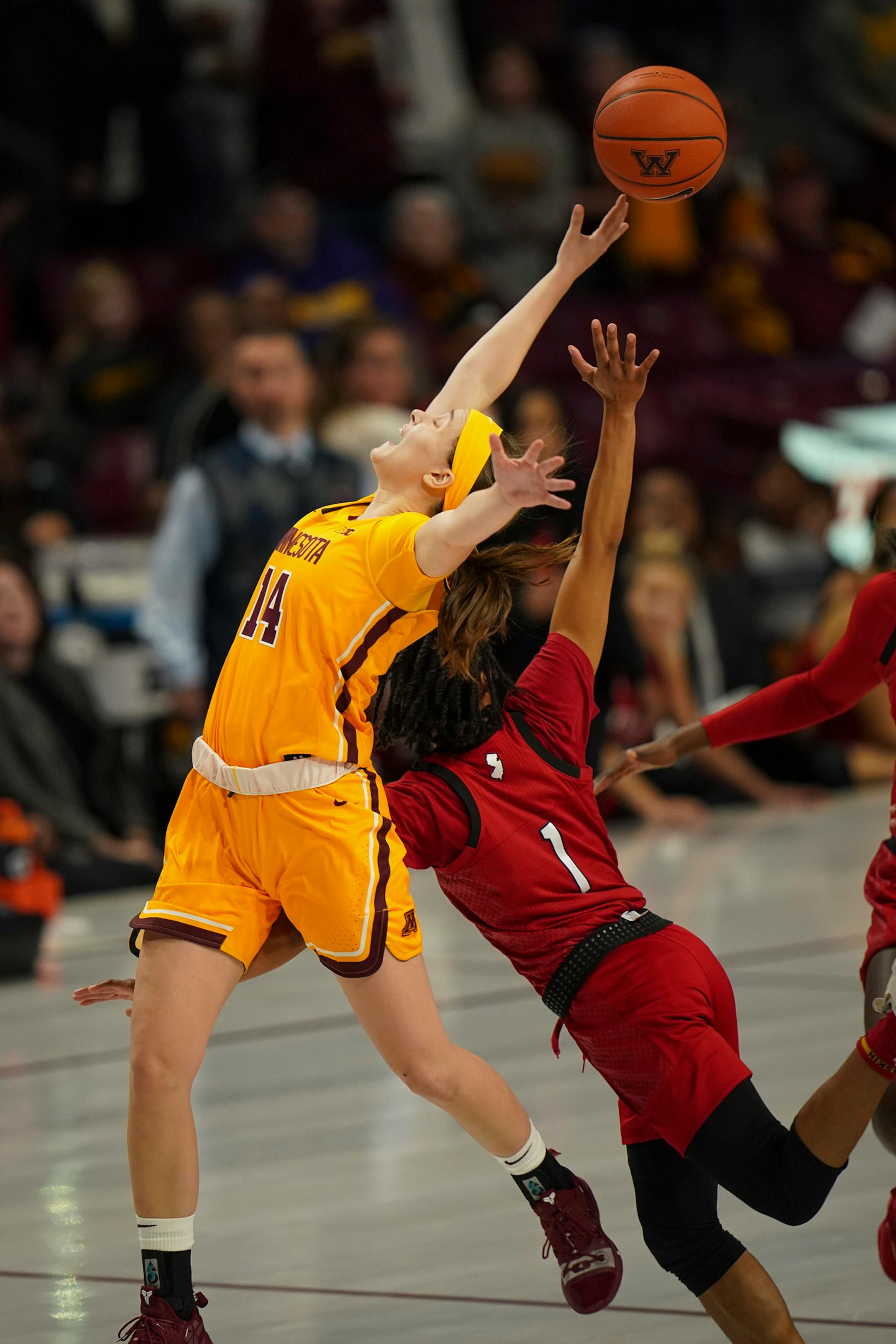 Minnesota Gophers guard Sara Scalia (14) was fouled as she reached for the long inbounds pass along with Rutgers Scarlet Knights guard Zipporah Broughton (1) late in the second overtime.