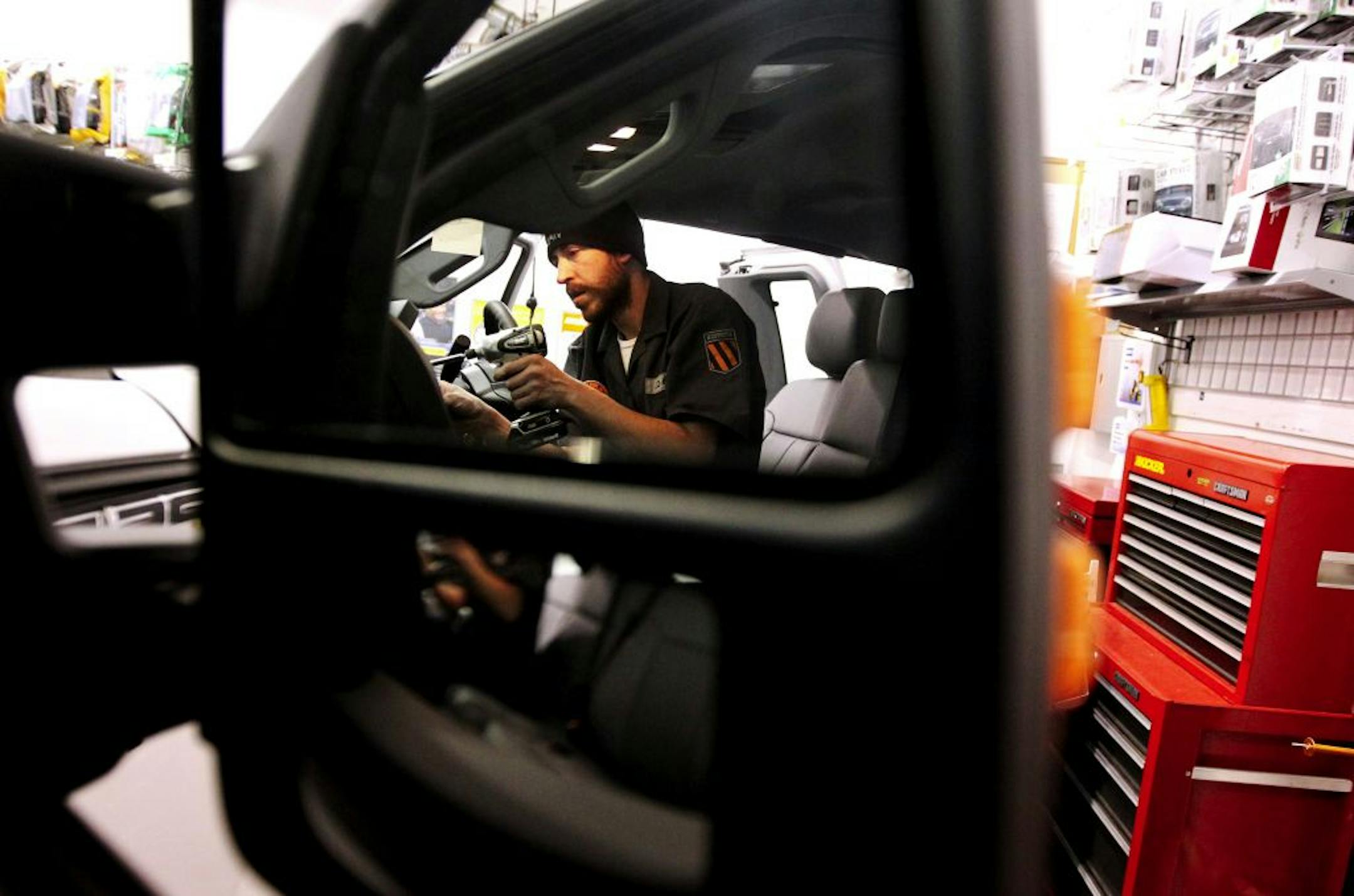 Best Buy Certified Autotech Jim Courtney installs an alarm and remote start unit in a corporate vehicle in the install bay in Best Buy in Eden Prairie February 22, 2012. Best Buy has recently entered a partnership with Car Toys.