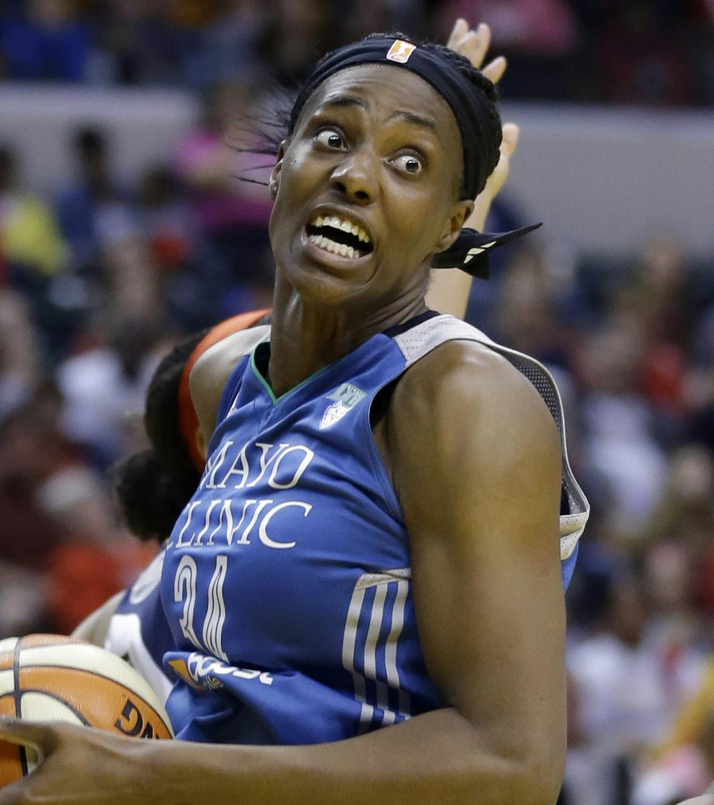 Minnesota Lynx's Sylvia Fowles, left, heads to the basket as Indiana Fever's Shenise Johnson defends in the second half of Game 4 of the WNBA Finals basketball series, in Indianapolis, Sunday, Oct. 11, 2015. (AP Photo/Michael Conroy)