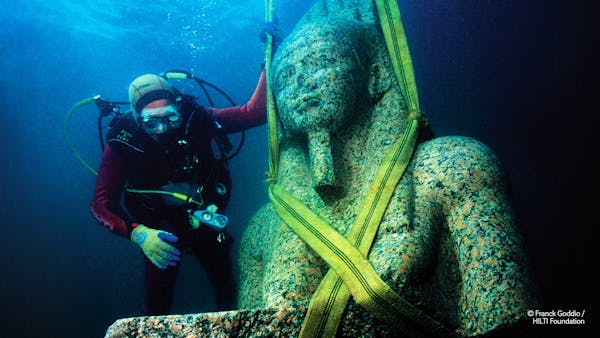 The bust of the colossal statue of Hapy, which weighs in at 9,700 pounds, before being cautiously raised out of the water of Aboukir bay, Egypt. It wi