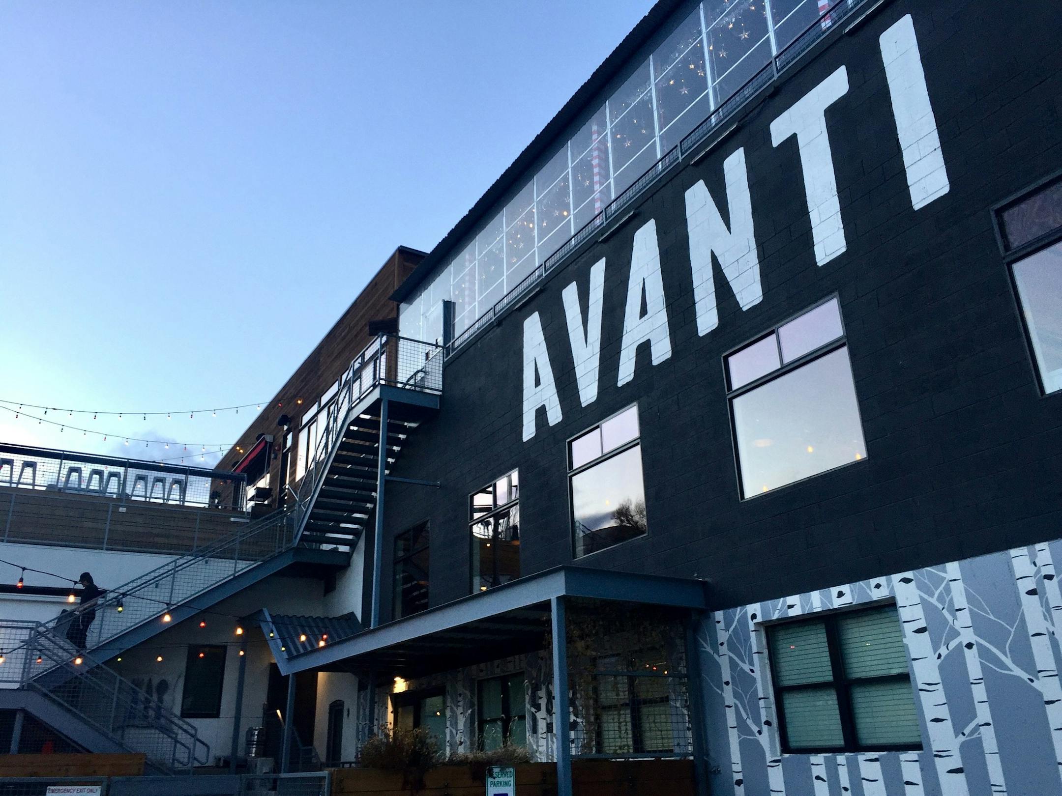 Avanti Food & Beverage in the LoHi neighborhood of Denver has a rooftop bar with views of the downtown skyline and is one of a growing number of food halls opening up in the Denver area.