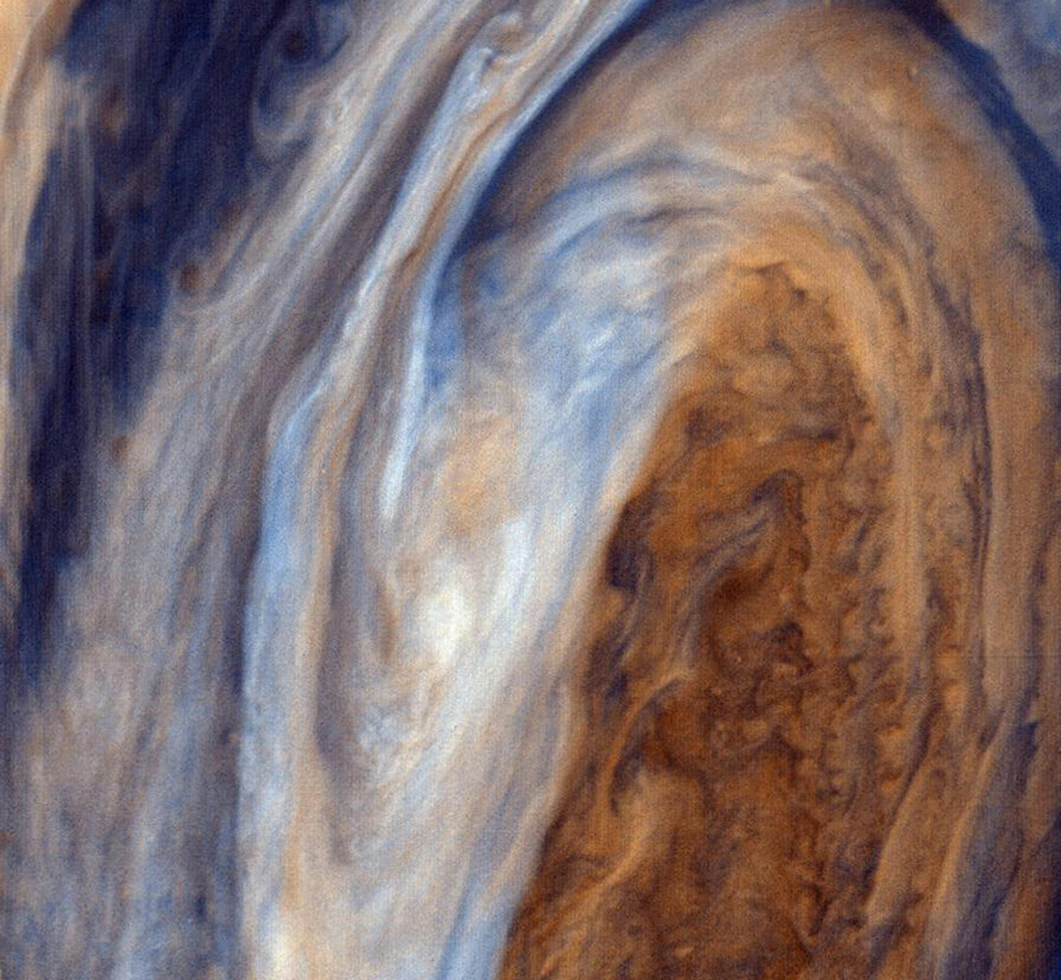 This view of the Great Red Spot is seen in greatly exaggerated color. The colors do not represent the true hues seen in the Jovian atmosphere but have been produced by special computer processing to enhance subtle variations in both color and shading. Credit: Courtesy of NASA/Jet Propulsion Laboratory