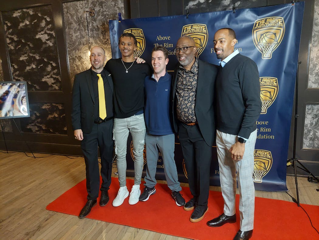 Larry McKenzie, second from right, posed with, from left, Trent Witz, Delshon Strickland, Nick Anderson and George Ellis on Sunday during a banquet in McKenzie’s honor.