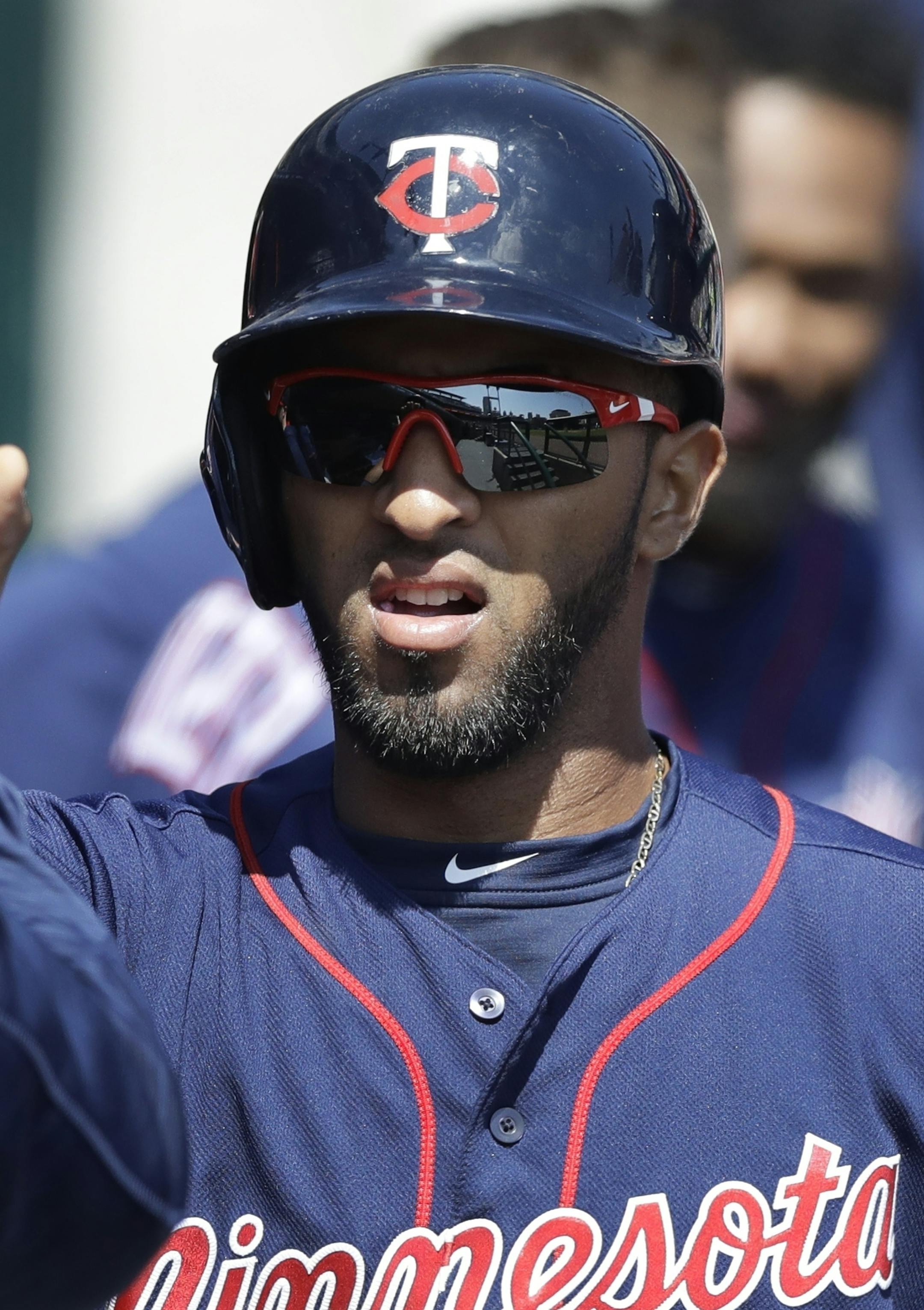 Minnesota Twins' Eddie Rosario greets teammates after scoring during the third inning of a baseball game against the Detroit Tigers, Wednesday, April 12, 2017, in Detroit. (AP Photo/Carlos Osorio)