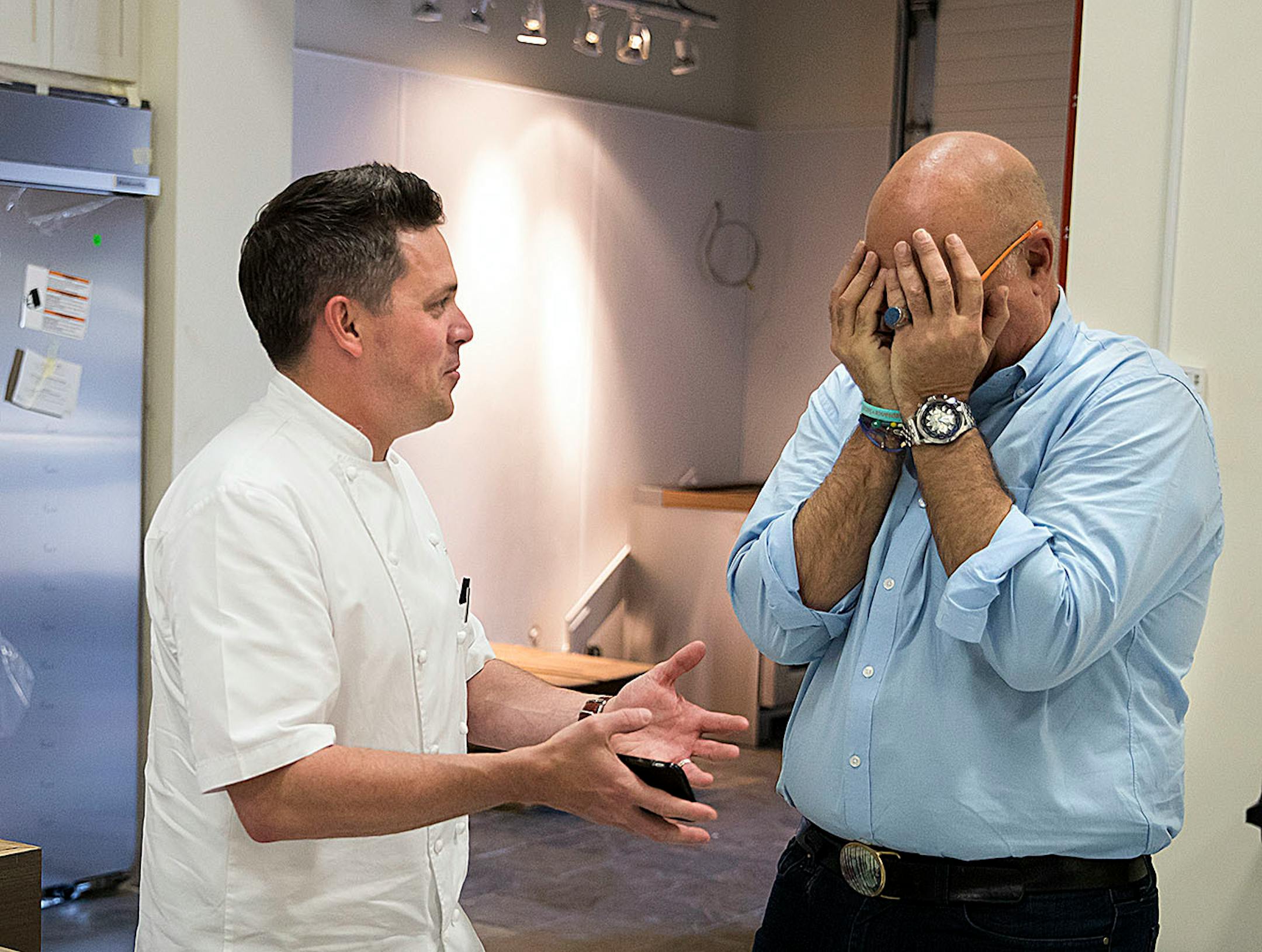 Andrew Zimmern burst into laughter while chatting with local chef Gavin Kaysen as the two talked after a meeting at the new office in St. Louis Park, Minn., on Friday, May 26, 2017. They are standing in the construction of a new kitchen studio that is part of the office.