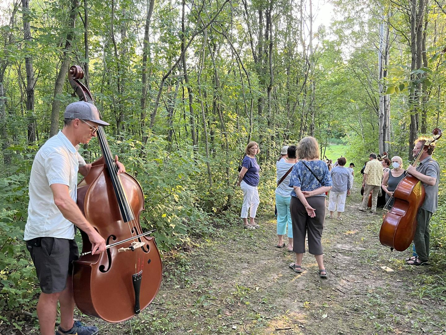 Double bassists perform 'Murmur in the Trees' in a grove at Caponi