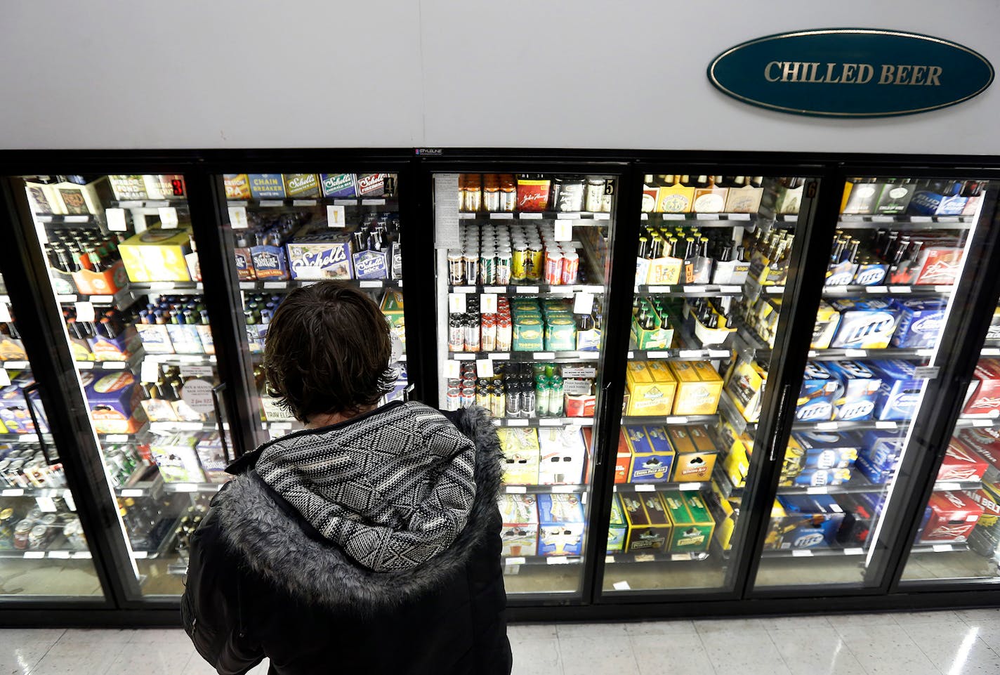 Christopher Hunt, 32, of Minneapolis shopped for beer at Surdyk's in Northeast Minneapolis on Monday. ] CARLOS GONZALEZ cgonzalez@startribune.com - February 4, 2013, Minneapolis, Minn., Surdyk's liquor store, story about the push to legalize Sunday liquor sales in Minnesota. ORG XMIT: MIN1302041712351382 ORG XMIT: MIN1403131557140354