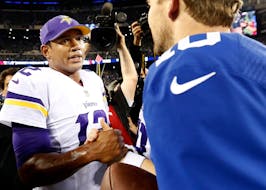Vikings quarterback Josh Freeman (12) shook hand with Giants quarterback Eli Manning at the end of the game. New York beat Minnesota by a final score 