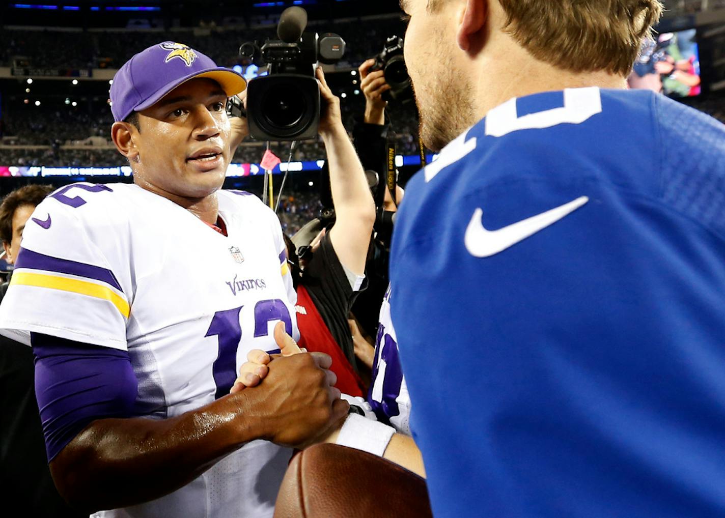 Vikings quarterback Josh Freeman (12) shook hand with Giants quarterback Eli Manning at the end of the game. New York beat Minnesota by a final score of 23-7.] CARLOS GONZALEZ cgonzalez@startribune.com October 21, 2013, East Rutherford, NJ, MetLife Stadium, Monday Night Football, NFL, Minnesota Vikings vs. New York Giants ORG XMIT: MIN1310212304321347