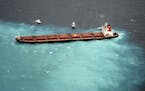 In this image provided by the Australian Maritime Safety Authority, the Chinese carrier Shen Neng 1 is hard aground on the Great Barrier Reef near Gre