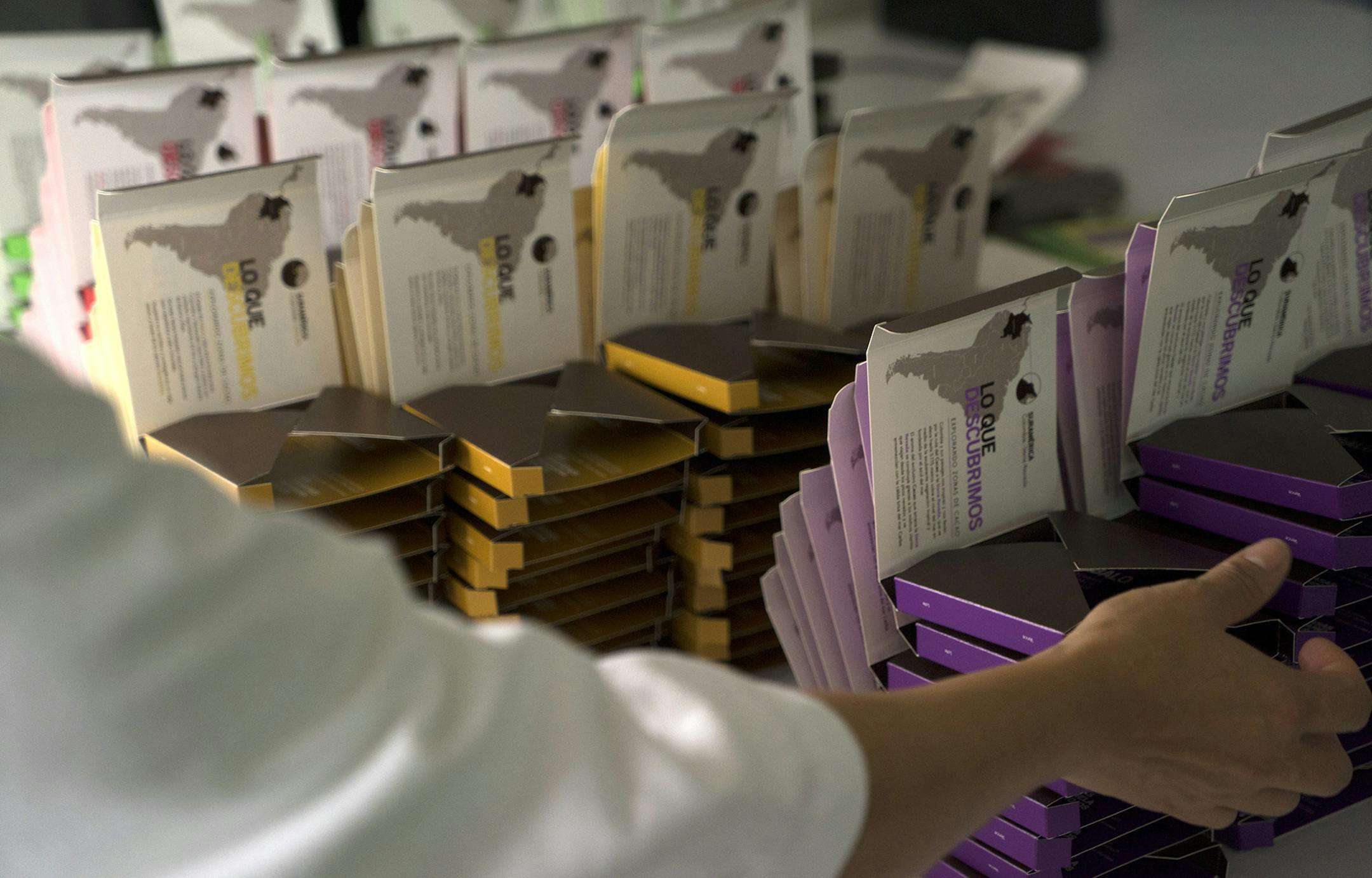A worker packages chocolate for export to Japan at the Cacao Hunters chocolate factory in Popayan, in the Cauca department of Colombia, on Monday, Oct. 6, 2014. Colombian cocoa growers have held talks with some of the world's top chocolate makers including Barry Callebaut AG and Ferrero SPA in a bid to replicate the success of the country's high-end coffee industry. Photographer: Mariana Greif Etchebehere/Bloomberg ORG XMIT: 517667489