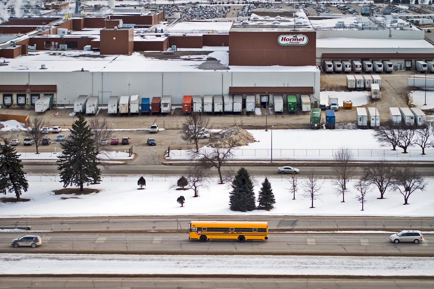 A school bus driving Austin's basketball teams to Rochester drove past the Hormel Foods plant, which employs much of the town. ] Aaron Lavinsky • aaron.lavinsky@startribune.com Photos to accompany a feature on the ethnic diversification of Austin Minn., as seen through the Austin High School boys basketball and soccer programs, photographed Tuesday, Feb. 4, 2020.