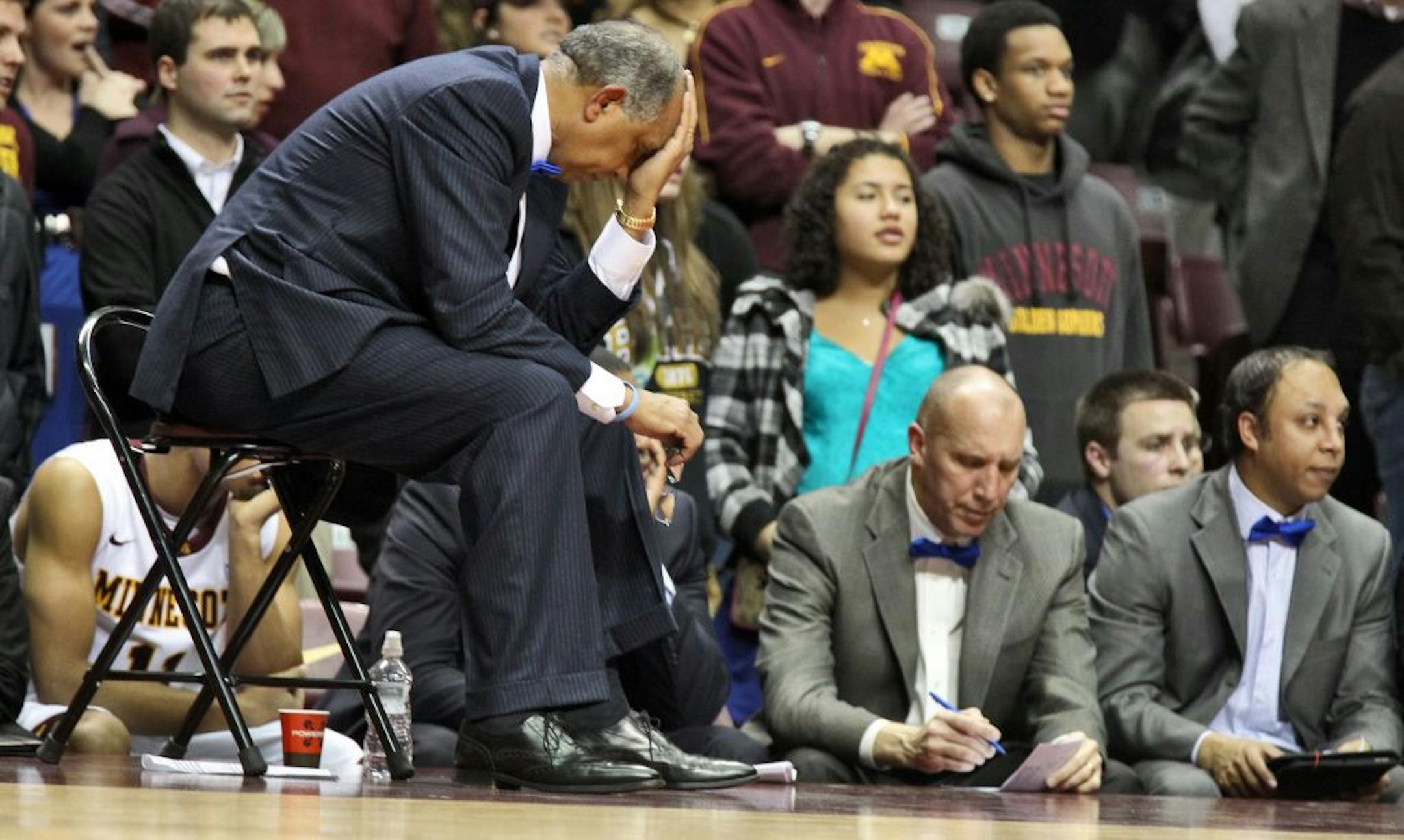 Gophers coach Tubby Smith, left, and his assistants felt the pain of another loss sink in.