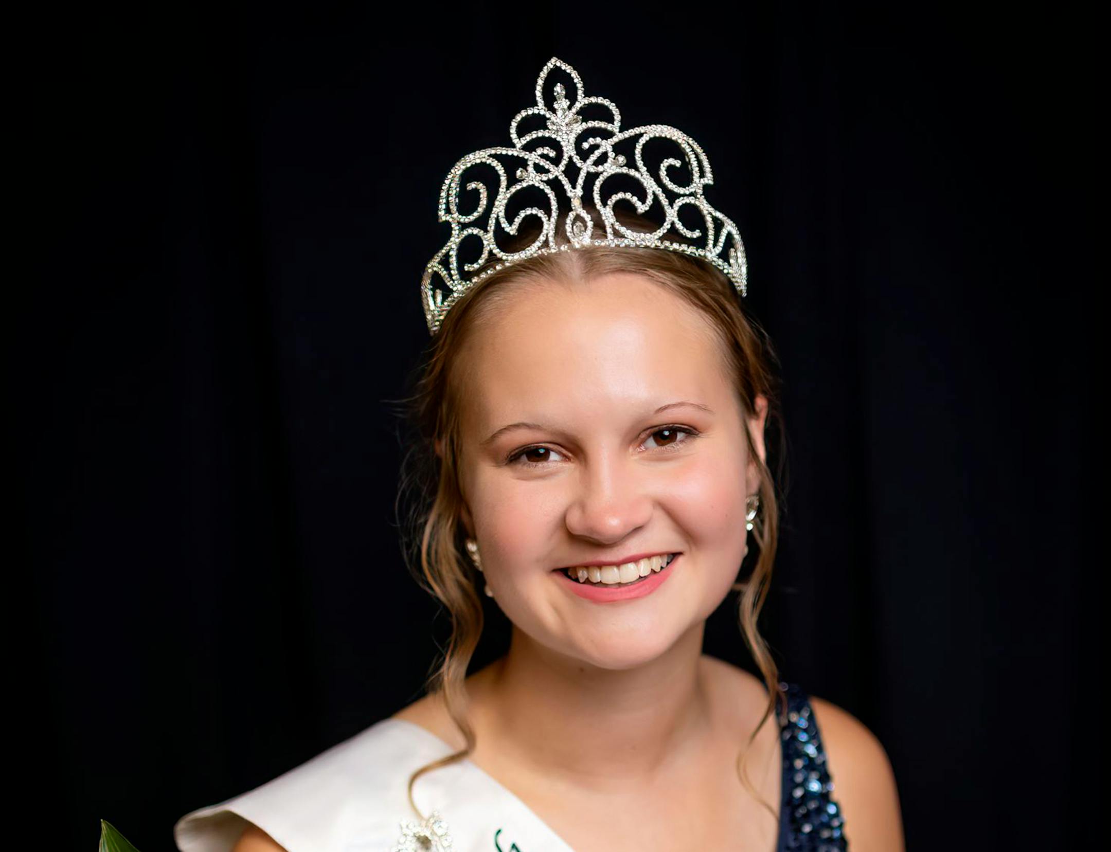 In a photo provided by Midwest Dairy, Anna Euerle, a 19-year-old college student from ­­Litchfield, Minn., representing Meeker County, smiles after being crowned Princess Kay of the Milky Way at the Minnesota State Fairgrounds on Wednesday, Aug. 25, 2021. (Matt Addington/Midwest Dairy via AP)