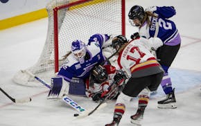 Minnesota Frost goaltender Maddie Rooney (35) blocks a shot by Ottawa Charge forward Victoria Bach (12) in the third overtime. The Minnesota Frost def