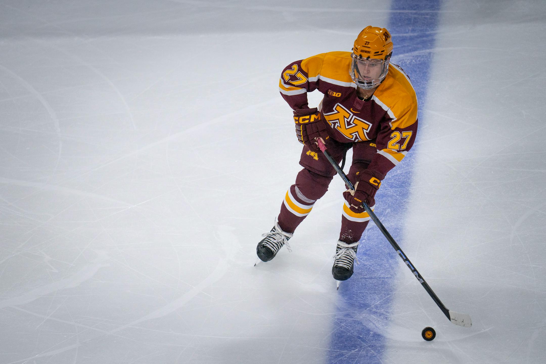Minnesota's Charlie Strobel (27, Forward) dribbles the puck during the game against Bemidji State University.