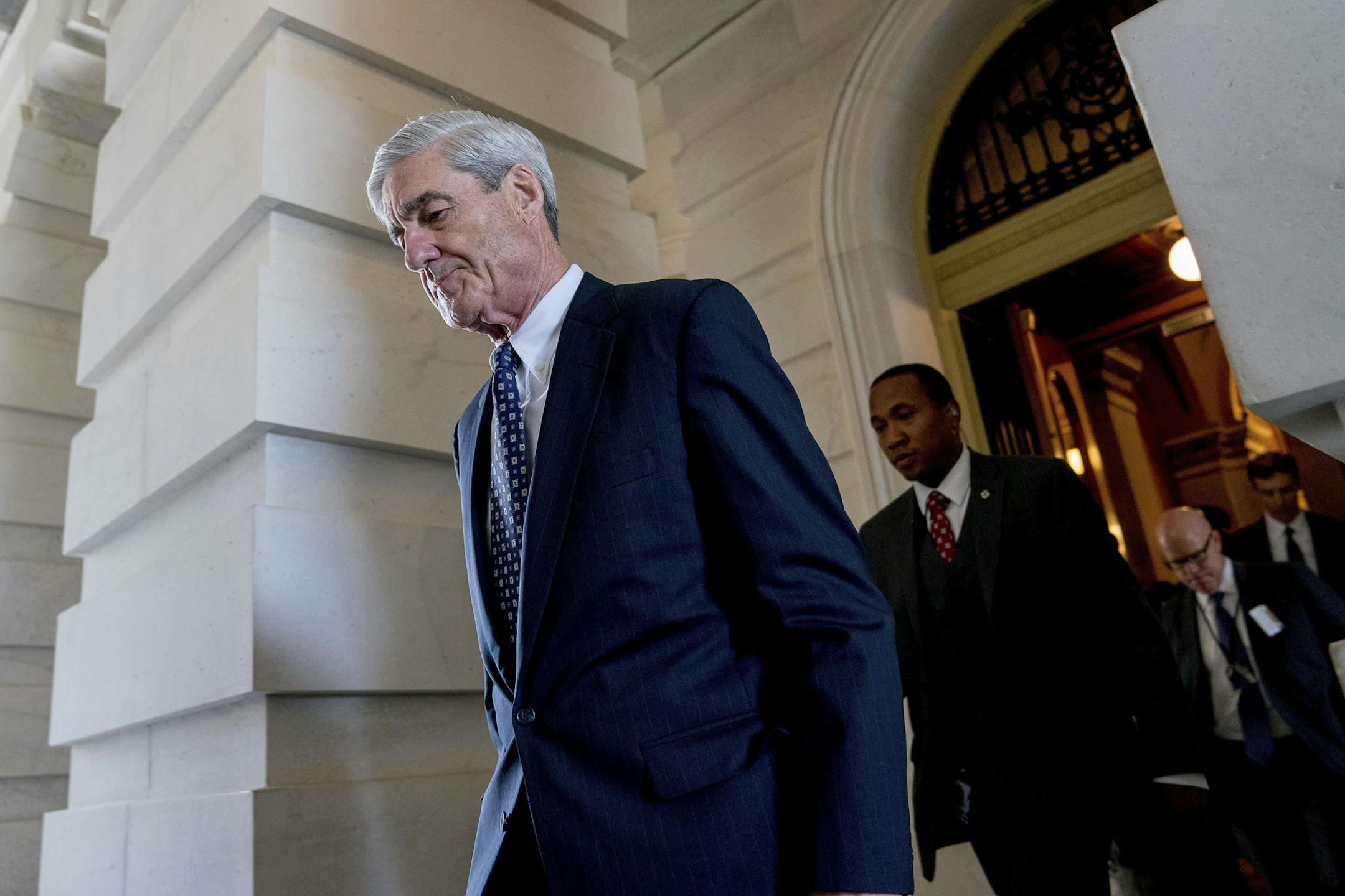 FILE- In this June 21, 2017, file photo, former FBI Director Robert Mueller, the special counsel probing Russian interference in the 2016 election, departs Capitol Hill following a closed door meeting in Washington. A grand jury used by Mueller has heard secret testimony from a Russian-American lobbyist who attended a June 2016 meeting with President Donald Trump's eldest son, The Associated Press has learned. (AP Photo/Andrew Harnik, File)