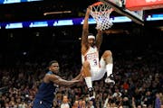 Suns guard Bradley Beal (3) dunks against the Wolves' Anthony Edwards during the first half of Friday night's blowout in Phoenix.