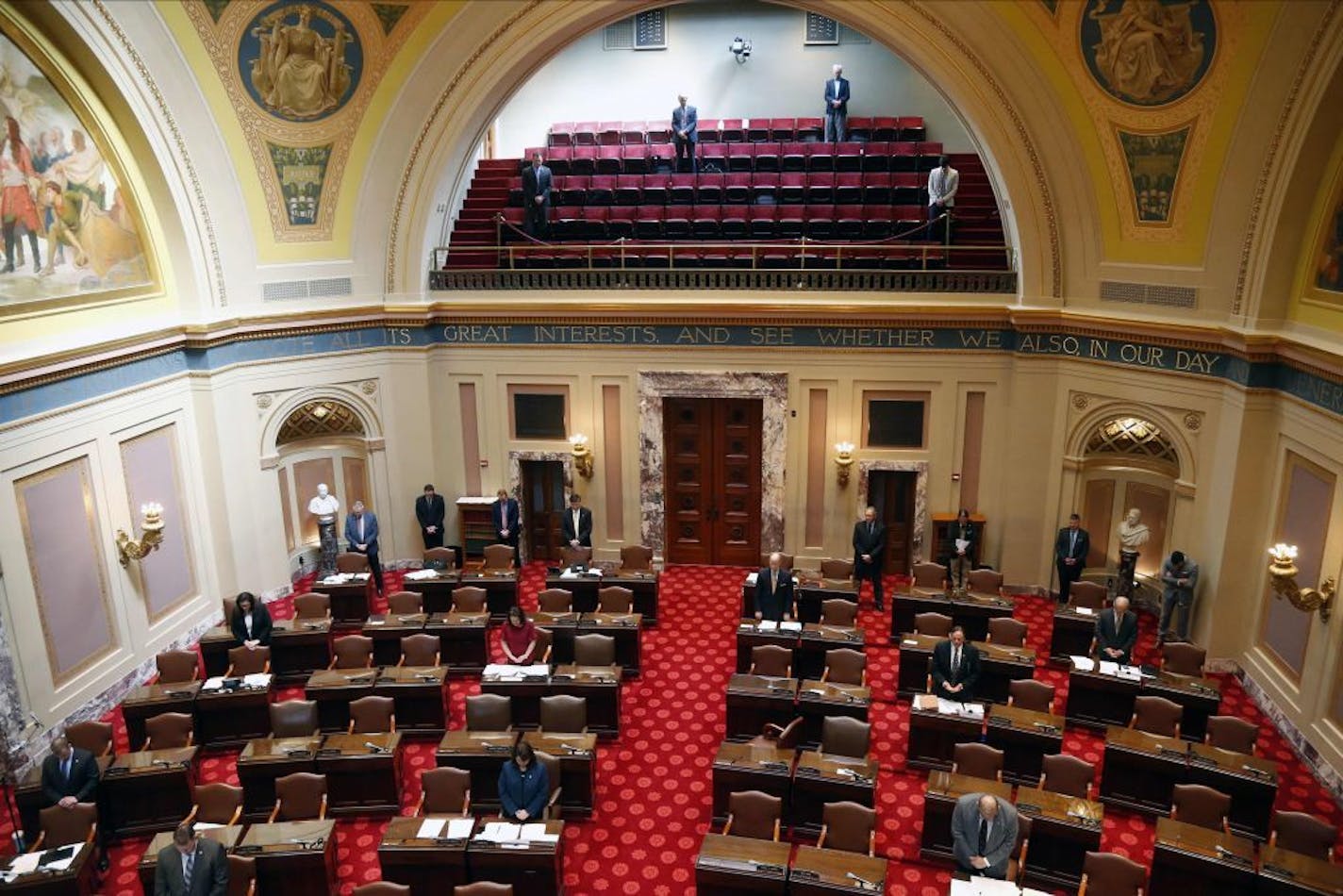 State senators keep their social distance in the gallery, other meeting rooms and the Senate chamber floor as the Minnesota State Senate met Thursday, March 26, 2020 at the State Capitol in St. Paul, Minn. to take up bills related to the coronavirus in the state. Due to social distancing, the gallery and other rooms were used for the lawmakers with the Senate floor limited to members. The new coronavirus causes mild or moderate symptoms for most people, but for some, especially older adults and