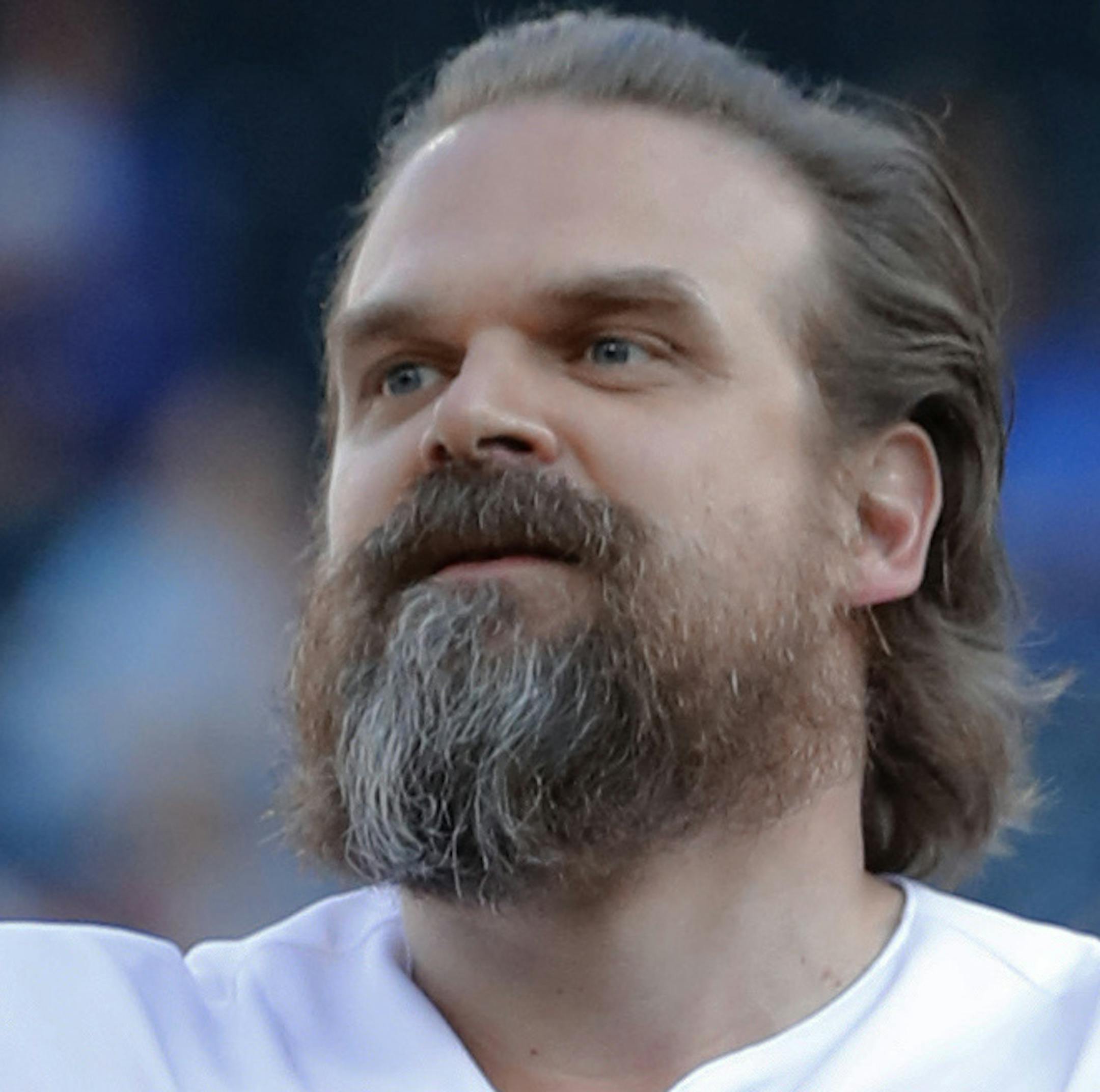 Actor David Harbour, who plays the sheriff on "Stranger Things," acknowledges cheers from fans after throwing out the ceremonial first pitch before a baseball game between the Texas Rangers and Cleveland Indians in Arlington, Texas, Tuesday, June 18, 2019. (AP Photo/Tony Gutierrez)