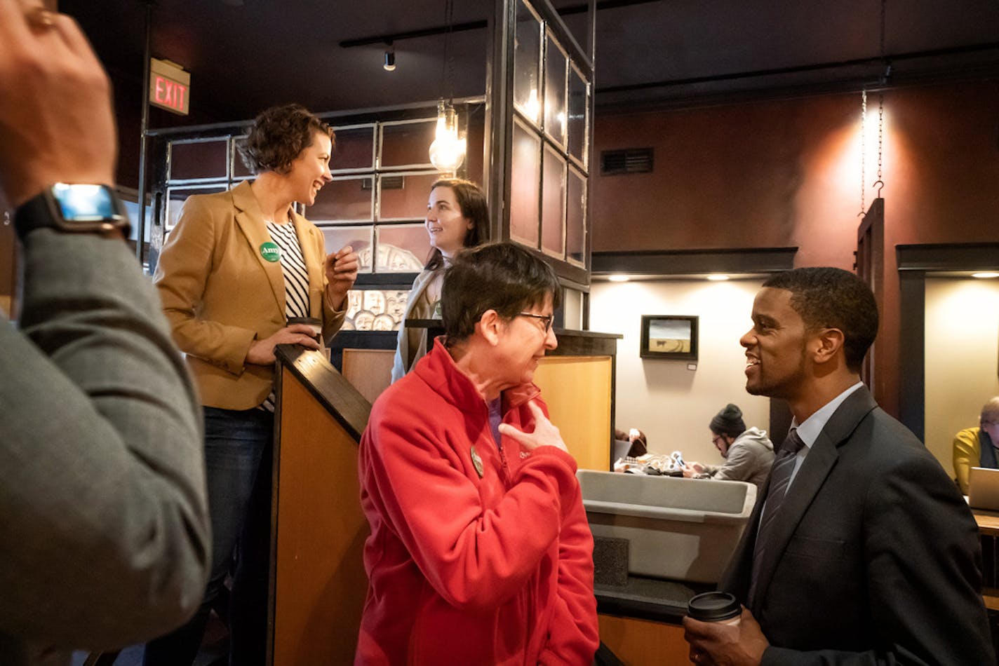 St. Paul Mayor Melvin Carter and Duluth Mayor Emily Larson talked with voters at a Main Street coffee shop in Ames, Iowa, on Jan. 31. They were stumping for then-presidential candidate Amy Klobuchar. Both mayors are now stumping for Joe Biden.