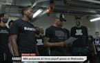 Members of the Milwaukee Bucks read a statement outside fo their locker room in Lake Buenavista, Fla., on Wednesday evening.