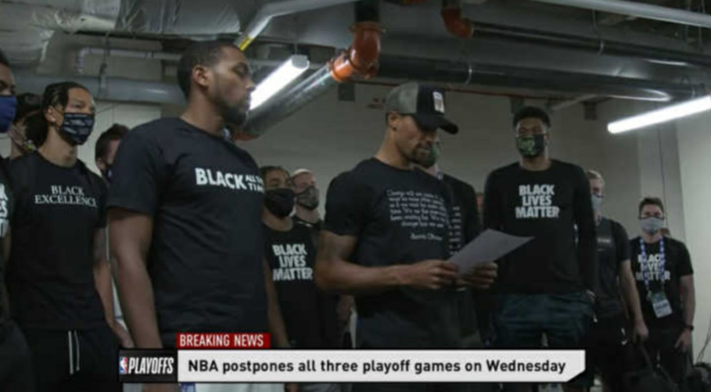 Members of the Milwaukee Bucks read a statement outside fo their locker room in Lake Buenavista, Fla., on Wednesday evening.