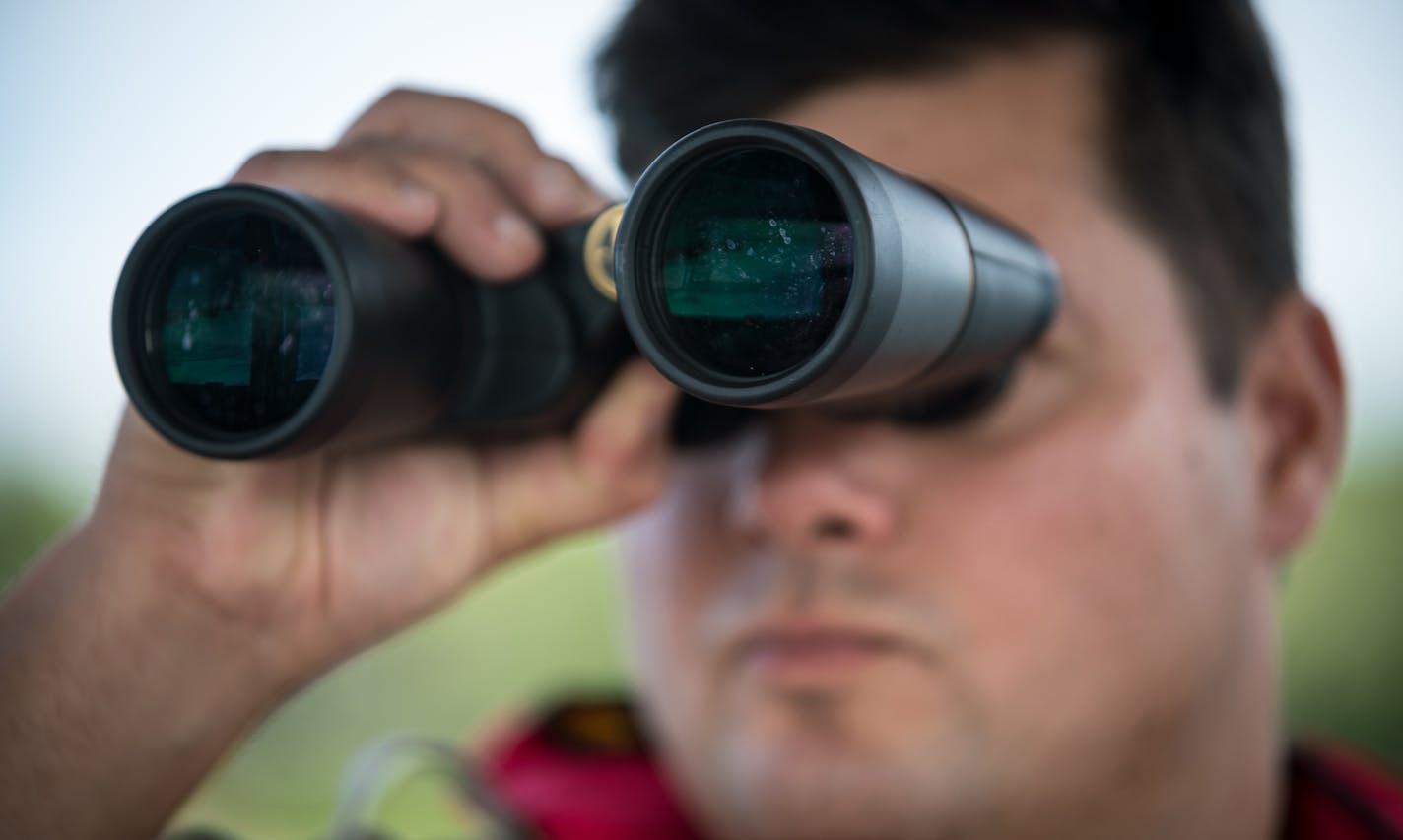 Hennepin County Sheriff's Office special deputy Amir Gharbi used binoculars to look for possible infractions being committed by boaters as he and deputy Jeremy Gunia patrolled Lake Minnetonka Saturday afternoon. ] (AARON LAVINSKY/STAR TRIBUNE) aaron.lavinsky@startribune.com We do a ride along with the Hennepin County Sheriff's Office Water Patrol, one of the largest such patrols in the country, as deputies patrol Lake Minnetonka on the final big boating weekend of the season. It's already been a