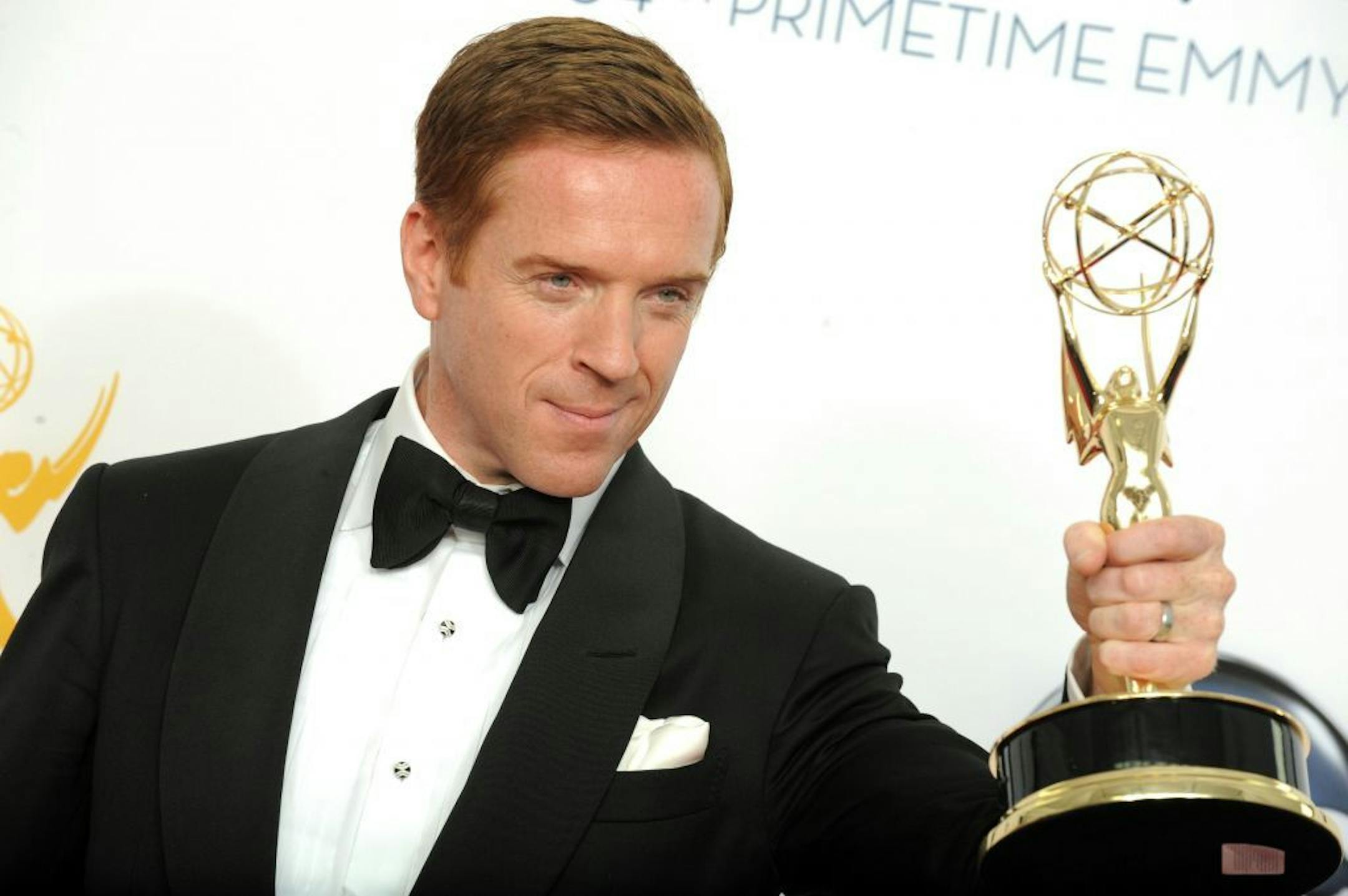 Actor Damien Lewis, winner of the Outstanding Lead Actor In A Drama Series award for "Homeland," poses backstage at the 64th Primetime Emmy Awards at the Nokia Theatre on Sunday, Sept. 23, 2012, in Los Angeles.