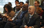 Former Supreme Court Justice Alan Page and Minneapolis Federal Reserve President Neel Kashkari, right, listened to speakers during the first Community