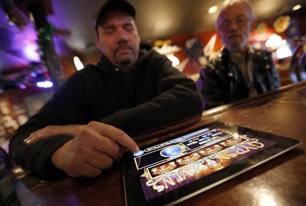 Dave Stokes of St. Paul played an electronic pulltab game at Skinner's Pub on Wednesday afternoon. ] CARLOS GONZALEZ cgonzalez@startribune.com - Decem