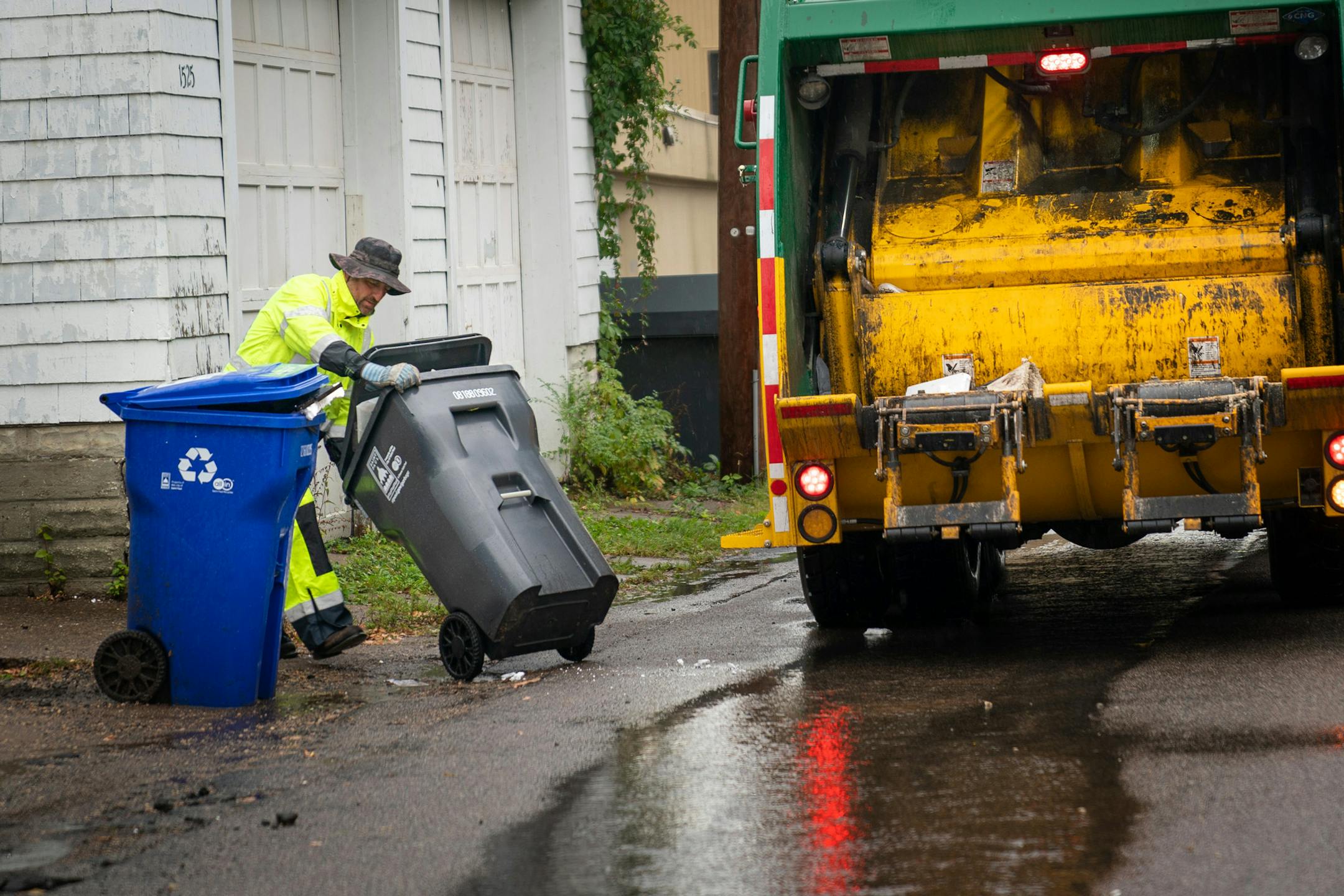 Waste Management worker Daniel Westerhaus collected trash from the alleys of the Snelling Hamline neighborhood of St Paul's yellow zone on the first day of organized trash collection. ] GLEN STUBBE &#x2022; glen.stubbe@startribune.com Monday, October 1, 2018 St. Paul has begun its organized trash collection, a dramatic shift in how the city collects its waste. Scattered reports of residents using the wrong bins, but so far no major snafus. What's Happening at this time: Organized trash collectio