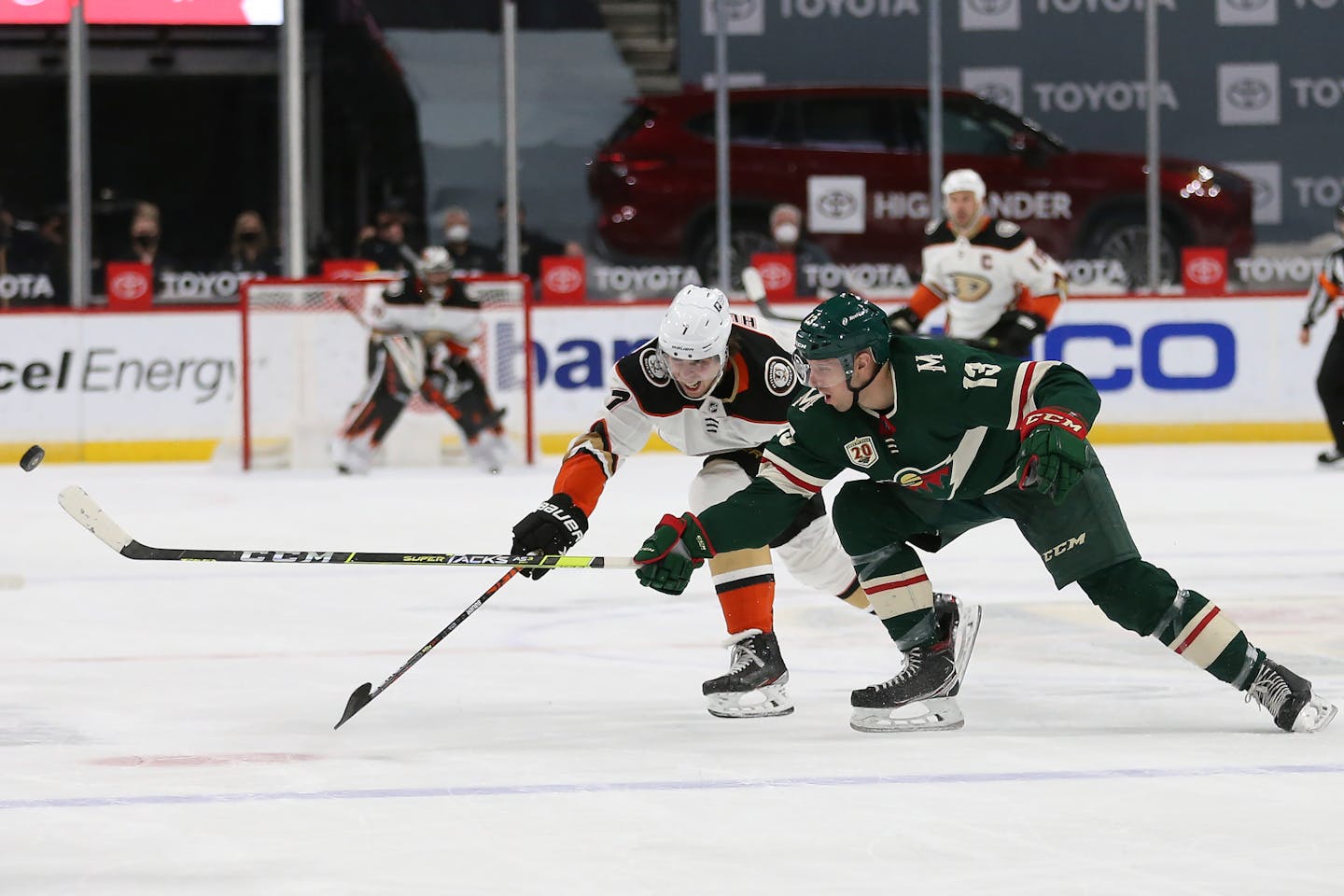 Anaheim's Ben Hutton (7) and the Wild's Nick Bonino (13) go after the puck during the second period on March 22