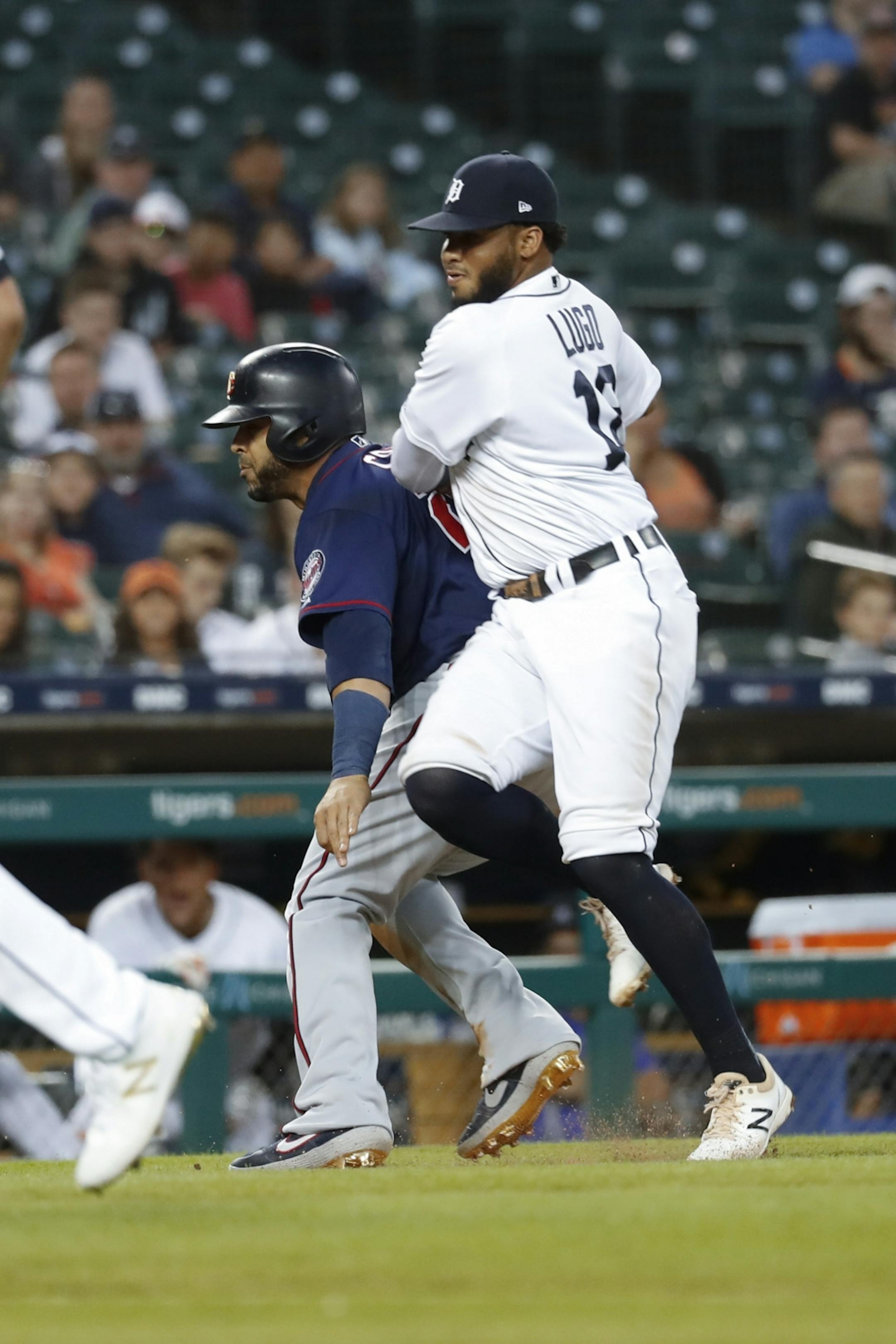 Detroit Tigers second baseman Dawel Lugo, right, tags Minnesota Twins' Nelson Cruz (23) out in the fourth inning of a baseball game in Detroit, Wednesday, Sept. 25, 2019.